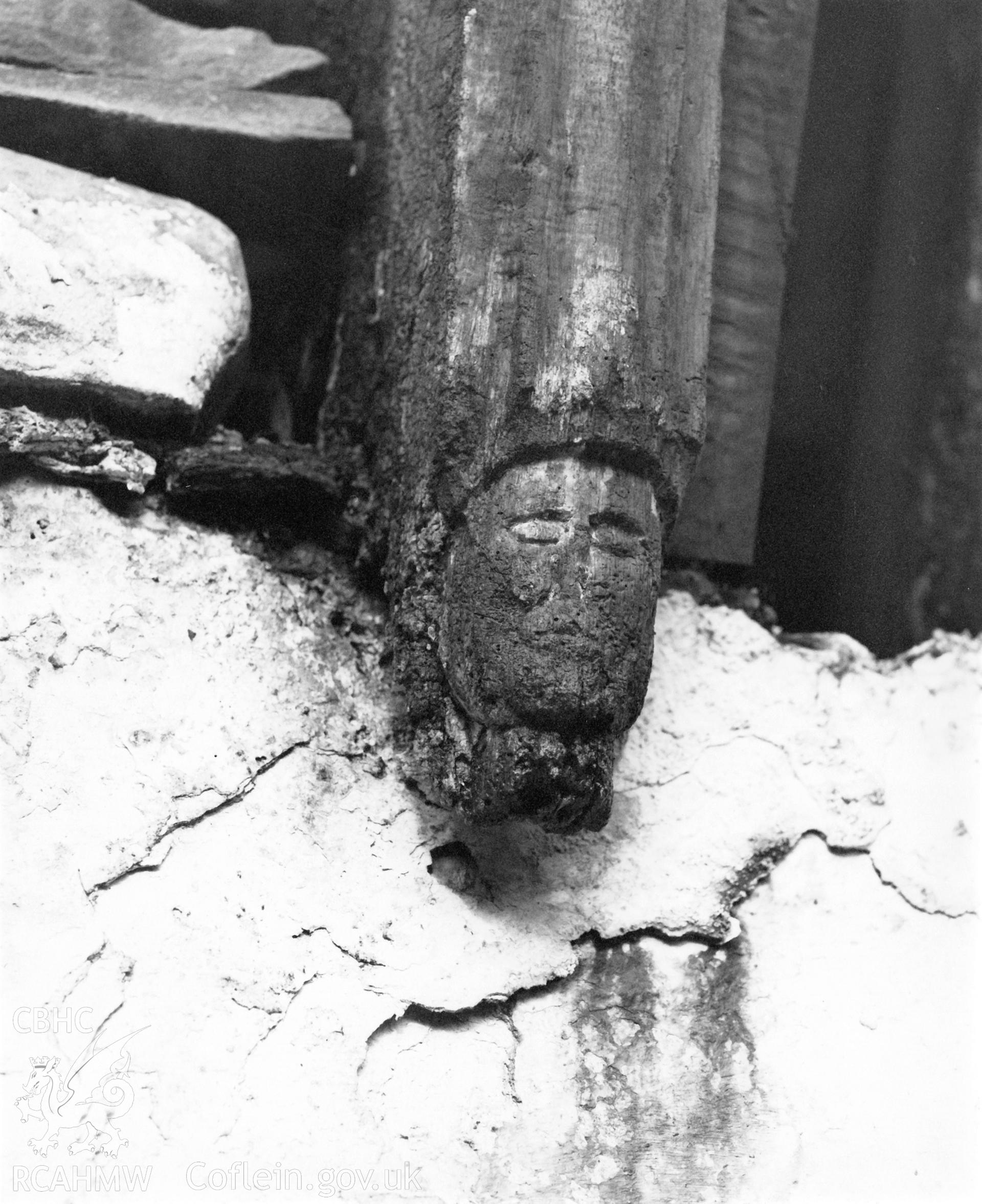 Carved head at foot of truss at St Teilo’s Church, Llandeilo Tal-y-bont. RCAHMW photograph (neg: 890013/20). Original not scanned. Scan of project print by Y Lolfa 2020. As featured in the RCAHMW volume, 'Temlau Peintiedig: Murluniau a Chroglenni yn Eglwysi Cymru, 1200–1800 / Painted Temples: Wallpaintings and Rood-screens in Welsh Churches, 1200–1800.' Figure 5.9, page 187.