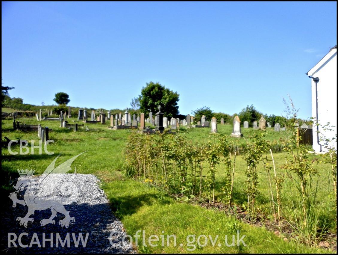 Photo taken in 2015 by Keith Bowen, 'showing the access to the Bwlchgwynt chapel cemetery for visitors, via a boundary gate positioned before you reach the Chapel. There is a line of trees/bushes planted to separate the boundary of the Chapel and the cemetery.'