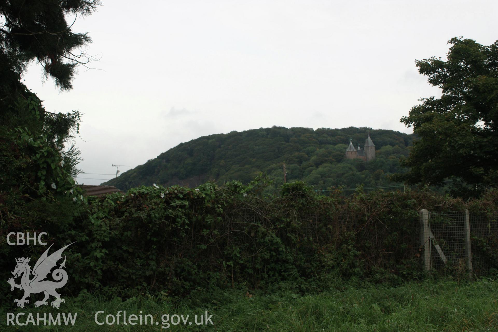 Colour digital image showing view to tree covered Motte with car park covering section of the Bailey in the foreground at Morganstown Motte, Radyr. From a Cambrian Archaeological Projects assessment survey by Dr Amelia Pannett (CAP Report 592)