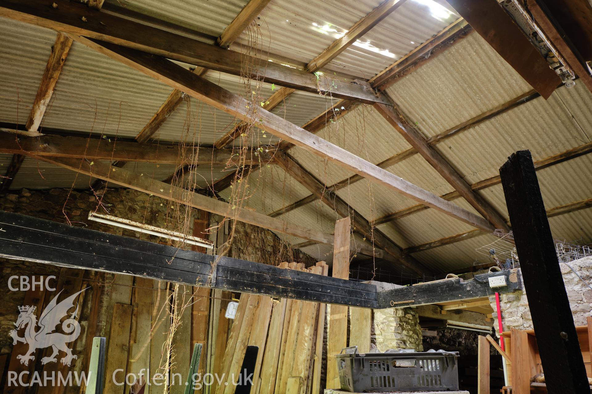 Colour photograph showing Blackpool Mill - former cottage & forge, roof trusses looking SW. Produced as part of Historic Building Recording for Blackpool Mill, carried out by Richard Hayman, June 2021.