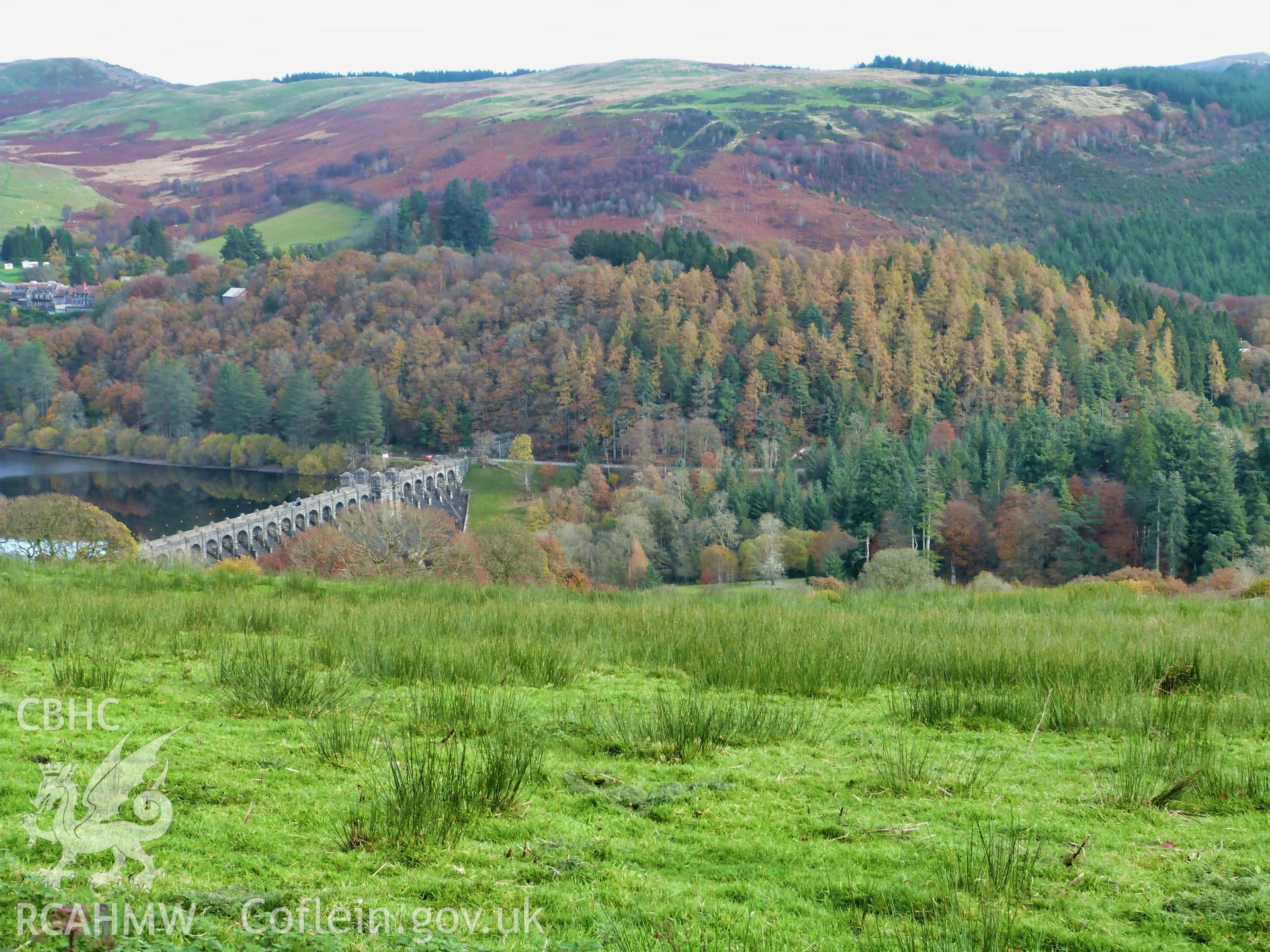 Colour digital photograph showing distant view of Lake Vyrnwy dam and filter house, taken in November 2021.