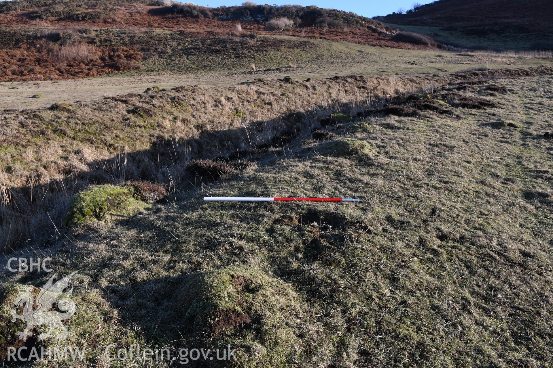 Inner ditch and ramparts. Camera facing S. 1m scale. From photographic survey of Castell Bach promontory fort (NPRN 93914) using 1m scales and human figures. Undertaken by Hannah Genders Boyd for CHERISH project condition monitoring 13/01/2022.
Produced with EU funds through the Ireland Wales Co-operation Programme 2014-2020. All material made freely available through the Open Government Licence.