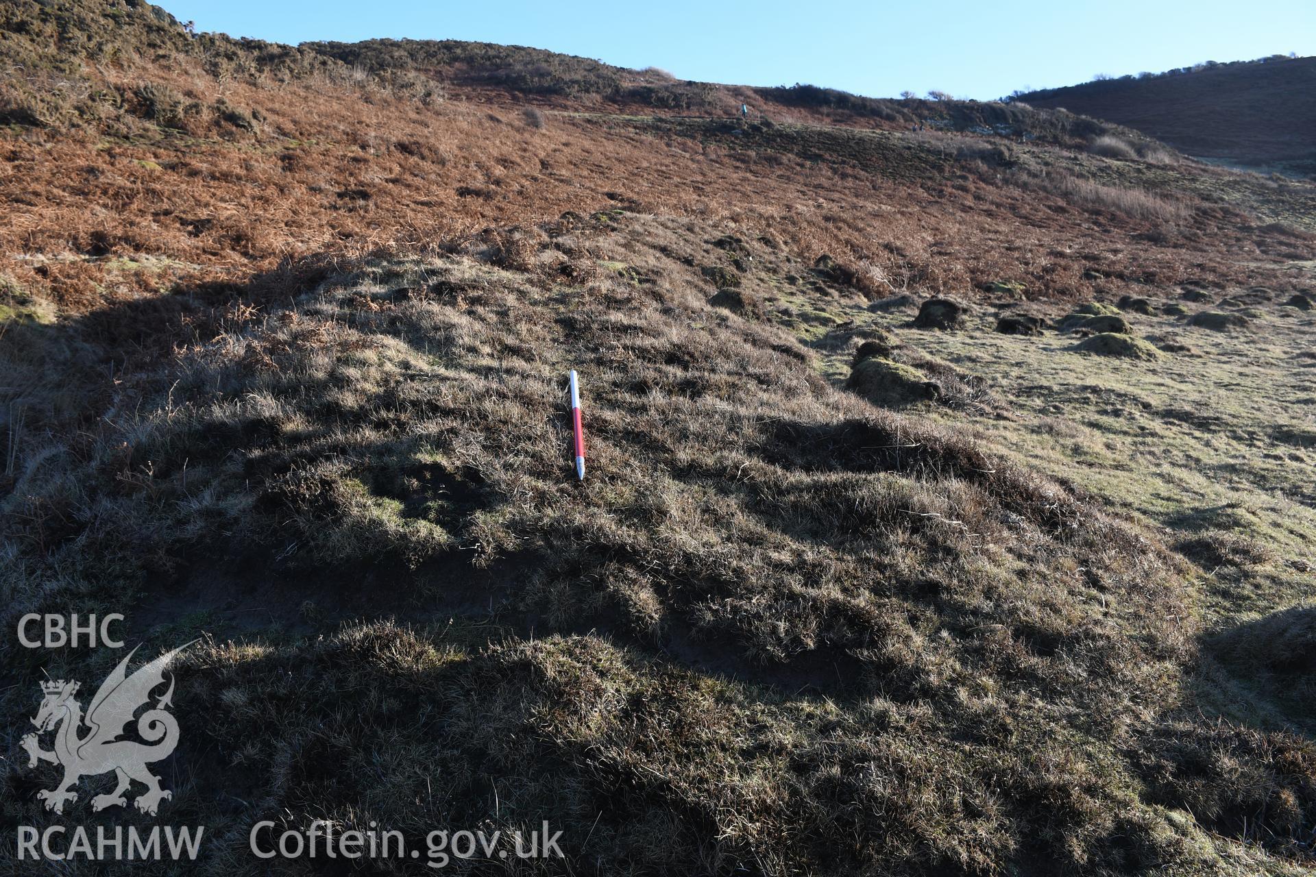 N end of outer rampart . Camera facing SE. From photographic survey of Castell Bach promontory fort (NPRN 93914) using 1m scales and human figures. Undertaken by Hannah Genders Boyd for CHERISH project condition monitoring 13/01/2022.
Produced with EU funds through the Ireland Wales Co-operation Programme 2014-2020. All material made freely available through the Open Government Licence.