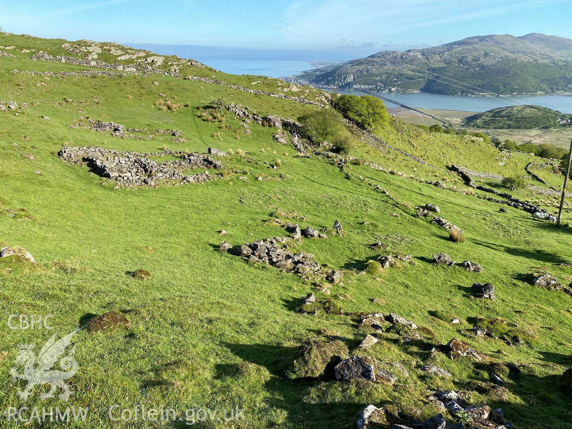 Digital colour photograph showing Cynfannedd longhuts, general view, produced by Paul R Davis in 2021.