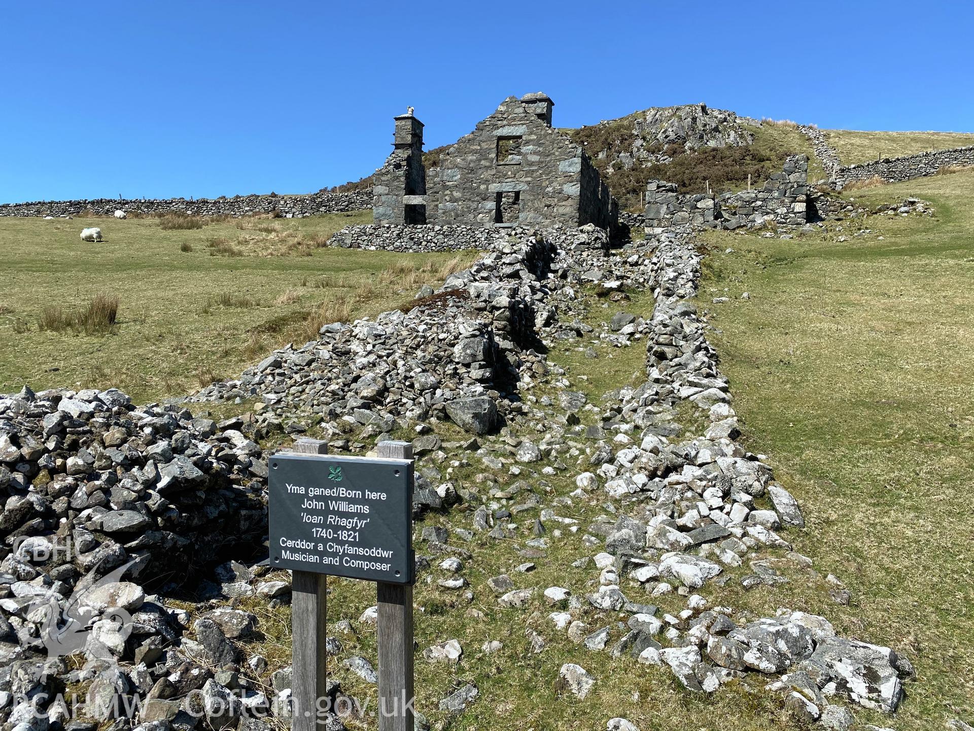 Digital colour photograph showing Hafotty-fach ruin with sign recording that the musician John Williams (Ioan Rhagfyr) was born here in 1740, produced by Paul R Davis in 2021.