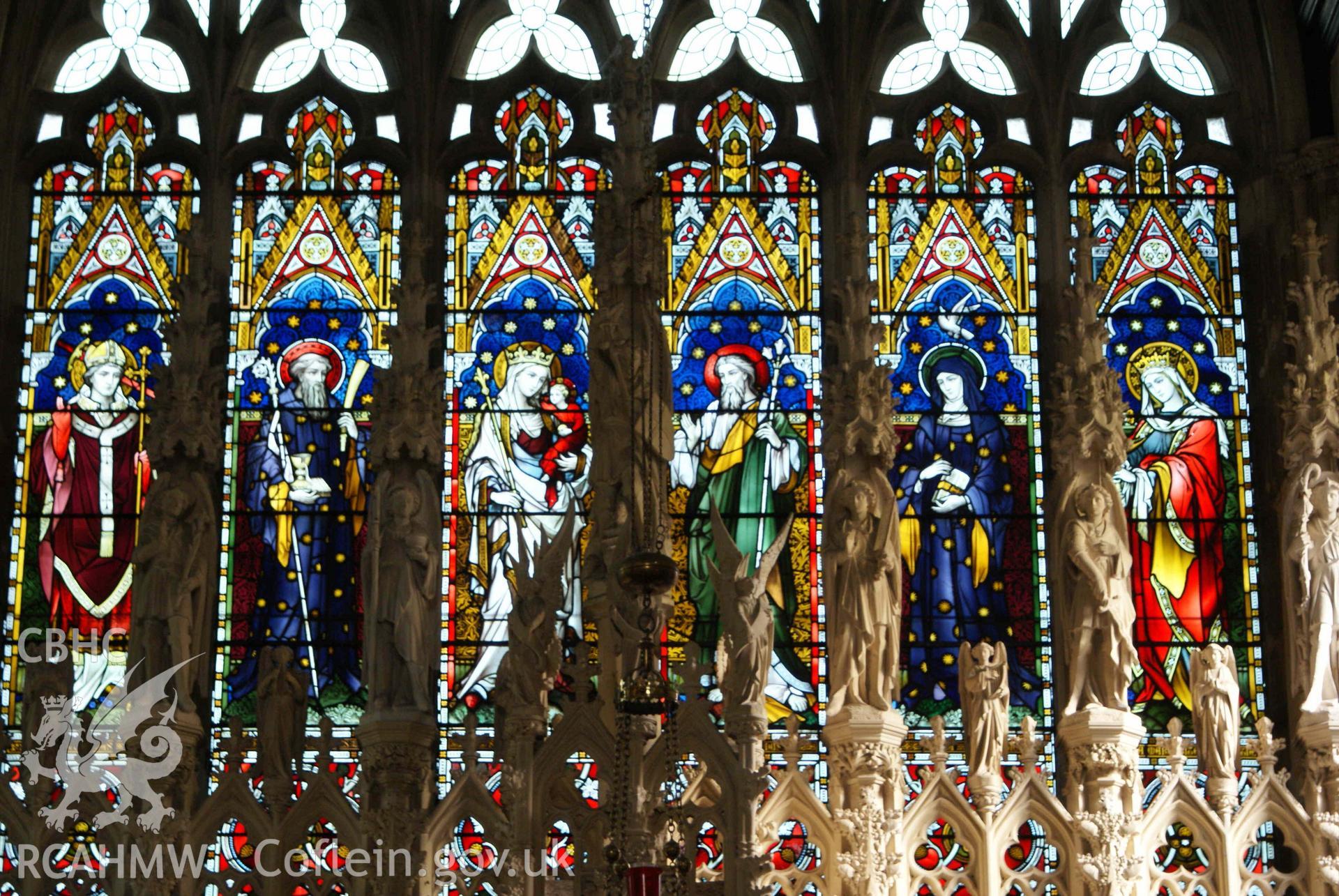 Digital colour photograph showing stained glass windows behind reredos, in Our Lady and St Michael Catholic church, Abergavenny.