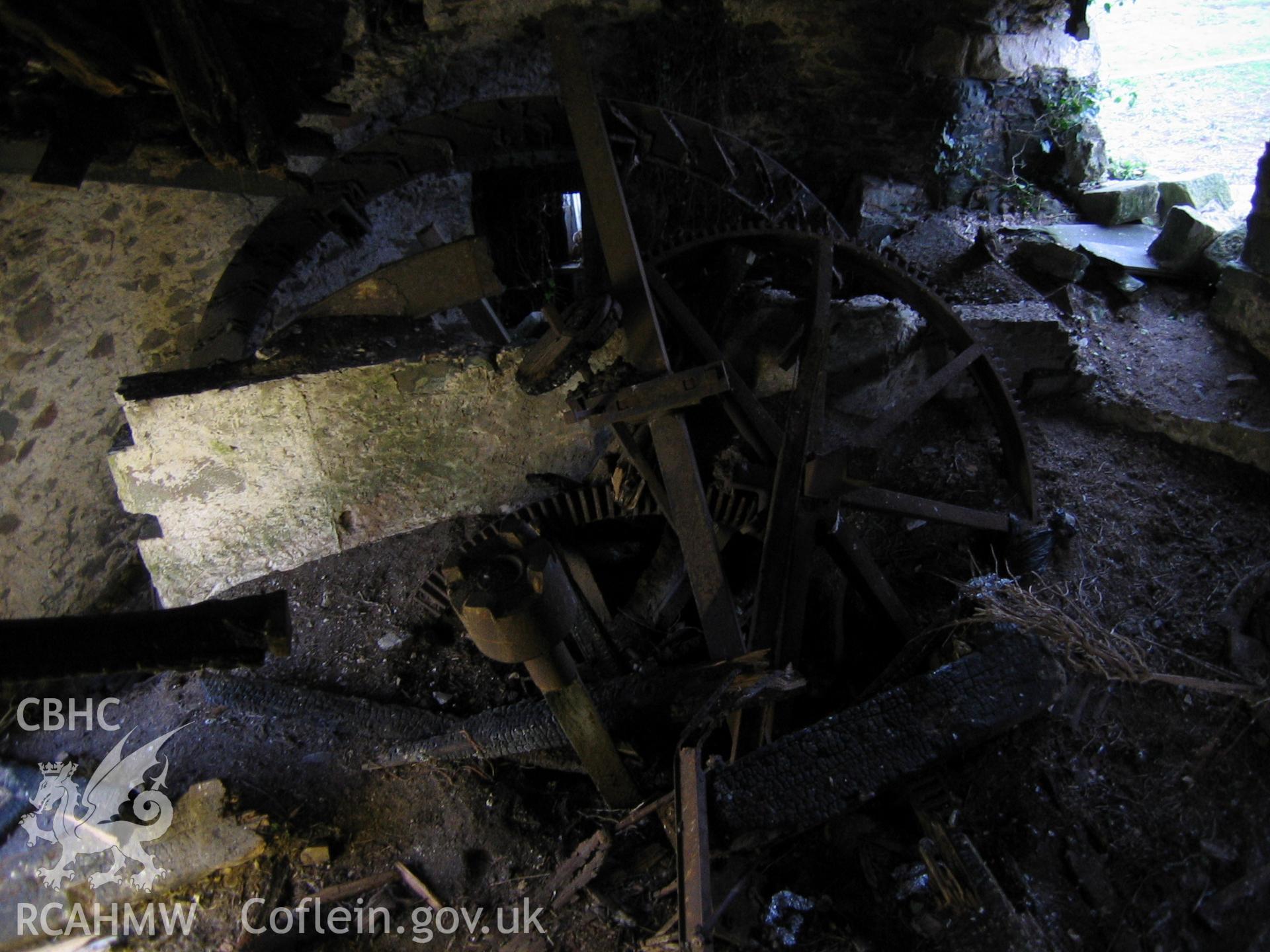 Digital photograph showing an assortment of disused mill machinery.