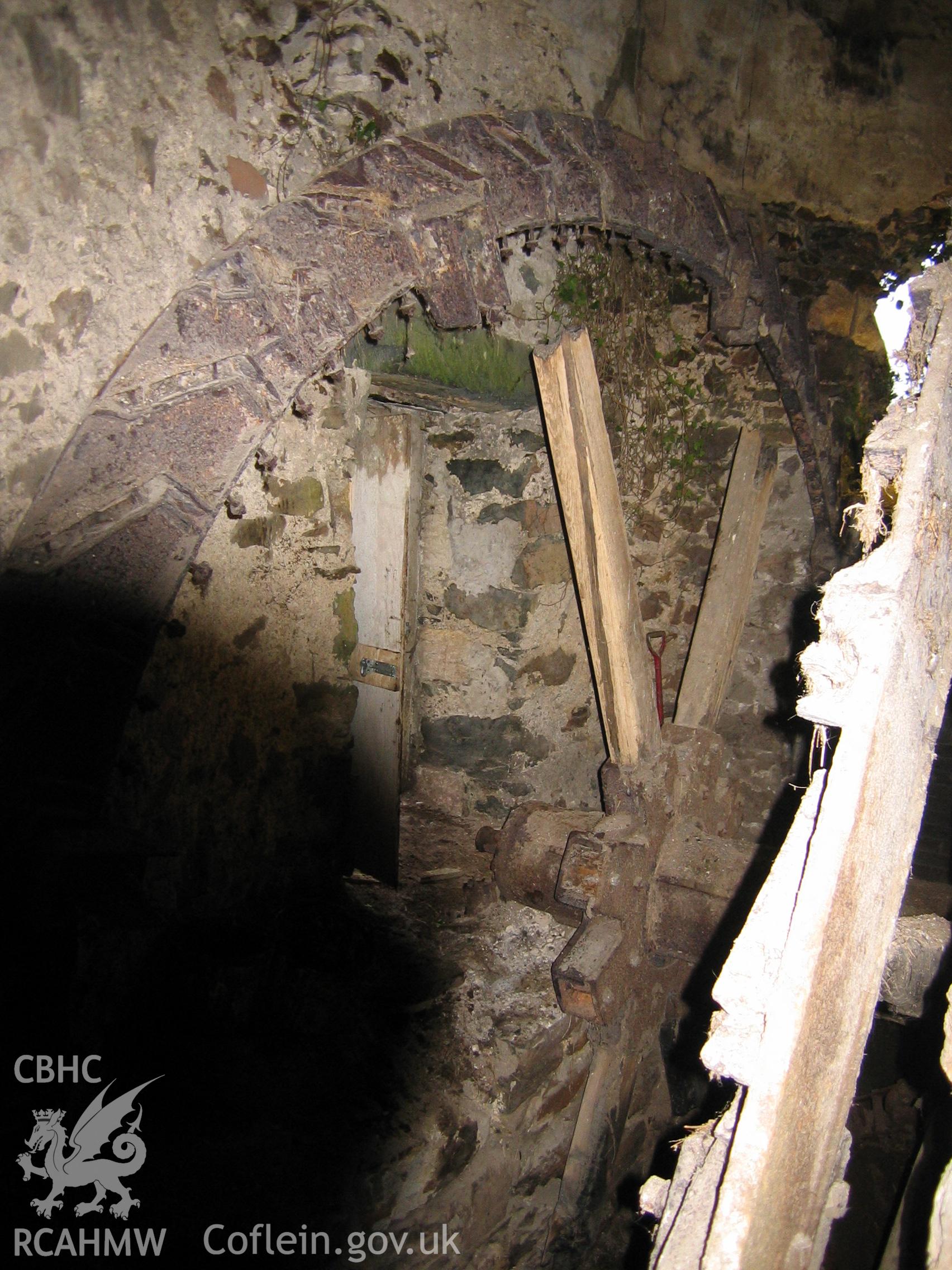 Digital photograph showing part of a disused water wheel.