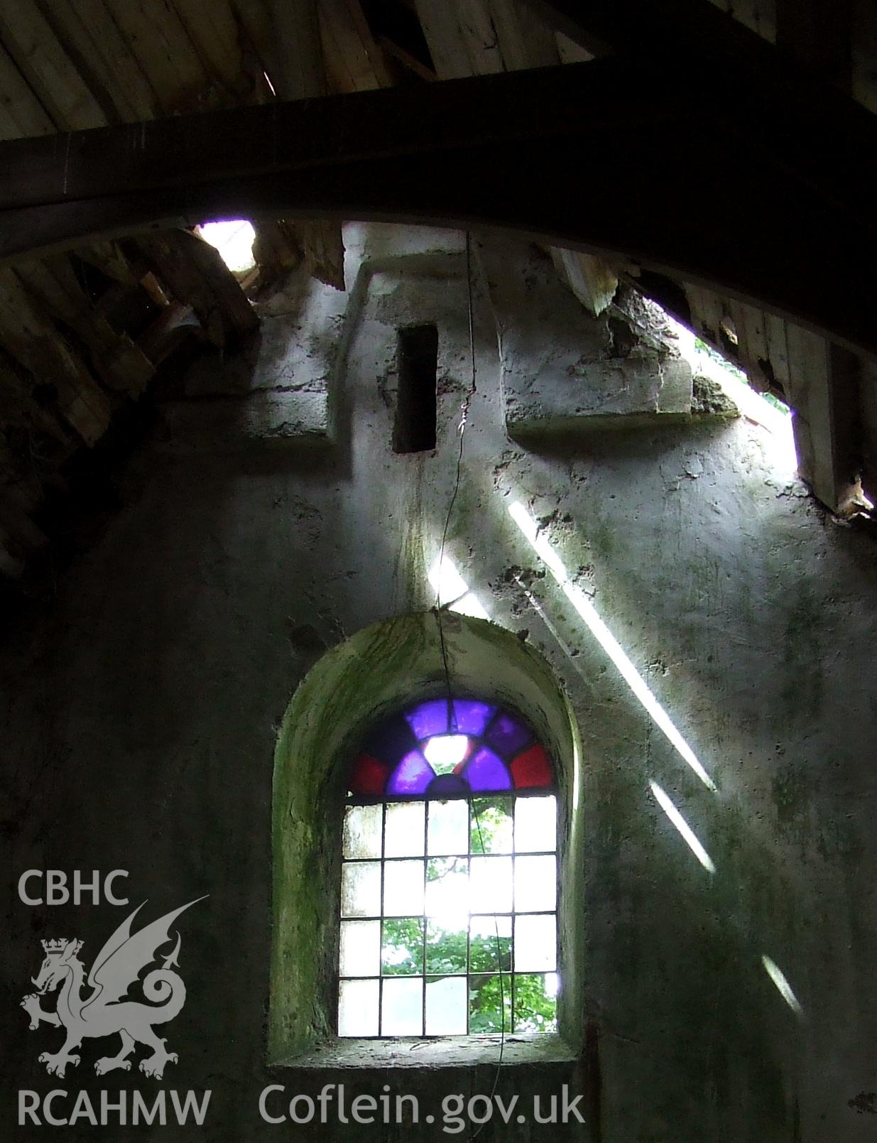 Digital colour photograph showing interior - projecting base possibly of original bellcote, at Castell Dwyran church.