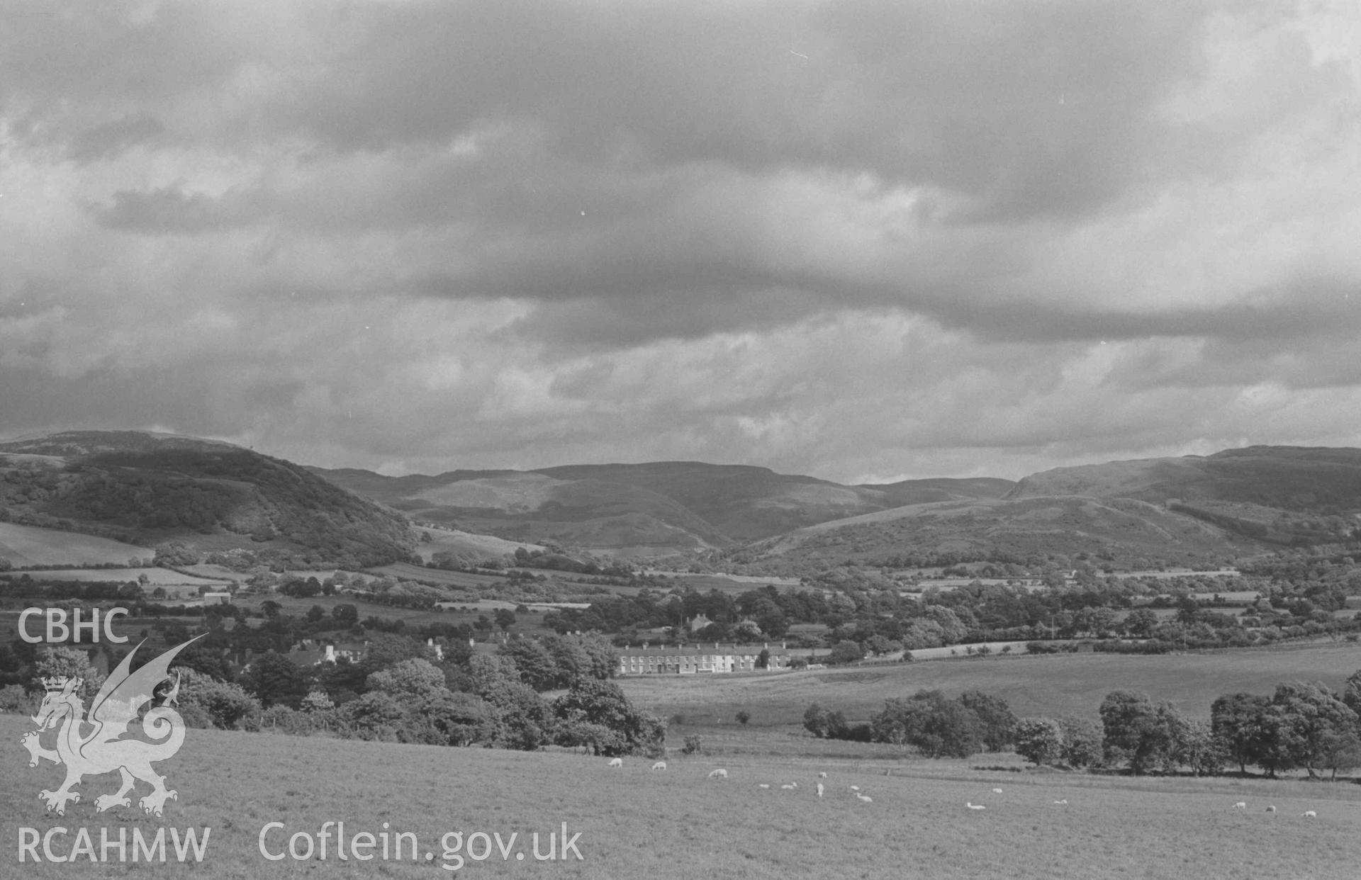 Digital copy of a black and white negative showing Pontrhydfendigaid and the Teifi valley from the road. Photographed by Arthur Chater on 18 August 1968. Looking east south east from Grid Reference SN 724 664.