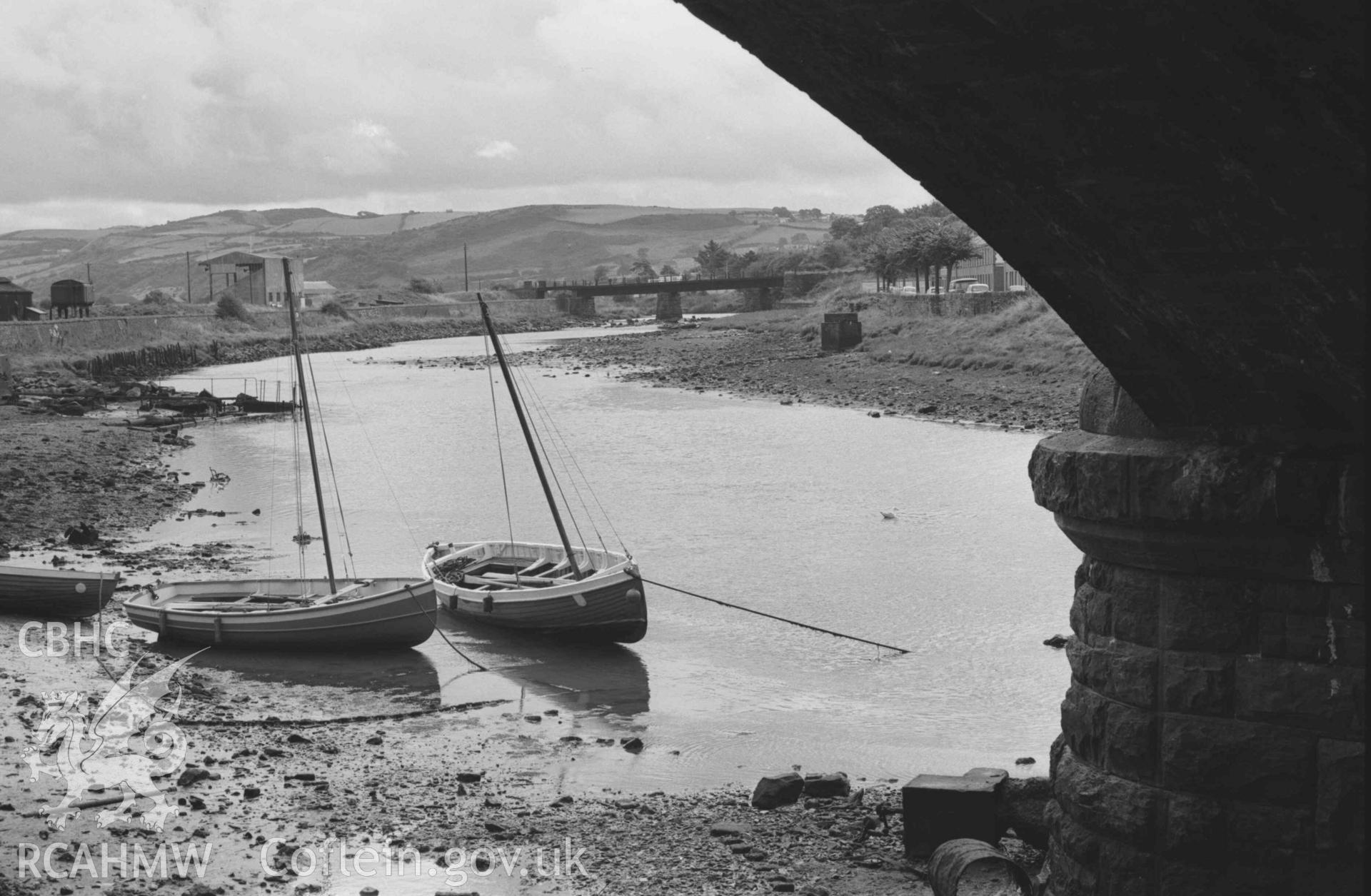 Digital copy of a black and white negative showing view looking up the Rheidol from under the north arch of Trefechan Bridge; railway bridge in distance. Photographed by Arthur Chater on 2 September 1968. Looking south east from Grid Reference SN 5827 8126.