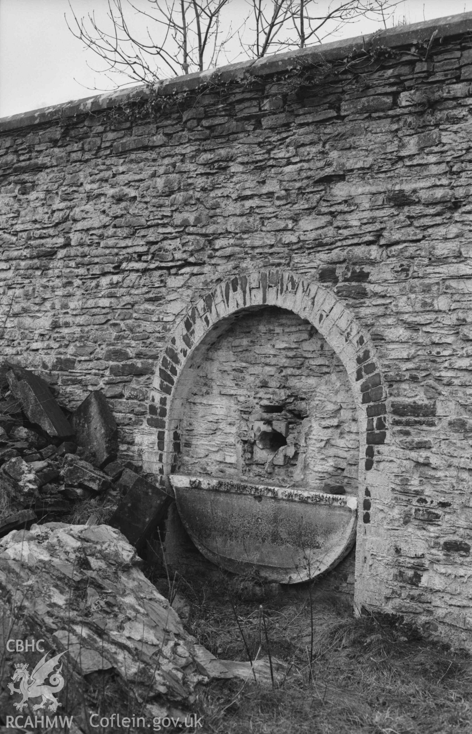 Digital copy of a black and white negative showing remains of marble scallop fountain on the wall at the back of Hafod-Uchtryd. Photographed by Arthur Chater on 23 December 1968. Looking west from Grid Reference SN 7494 7326.