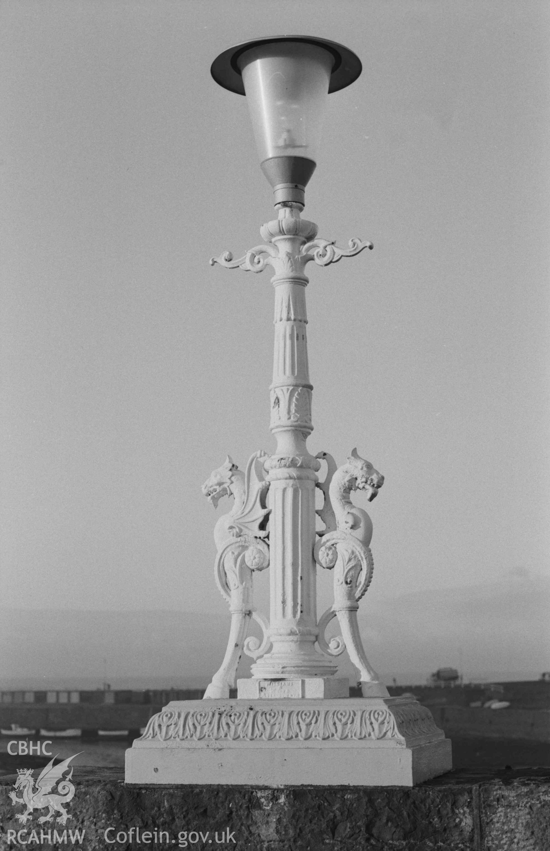 Digital copy of a black and white negative showing cast iron lamp standard on Trefechan Bridge marked 'WILLIAMS & WHITE ABERYSTWYTH'. Photographed by Arthur Chater on 27 December 1968. Looking west from Grid Reference SN 5827 8133.