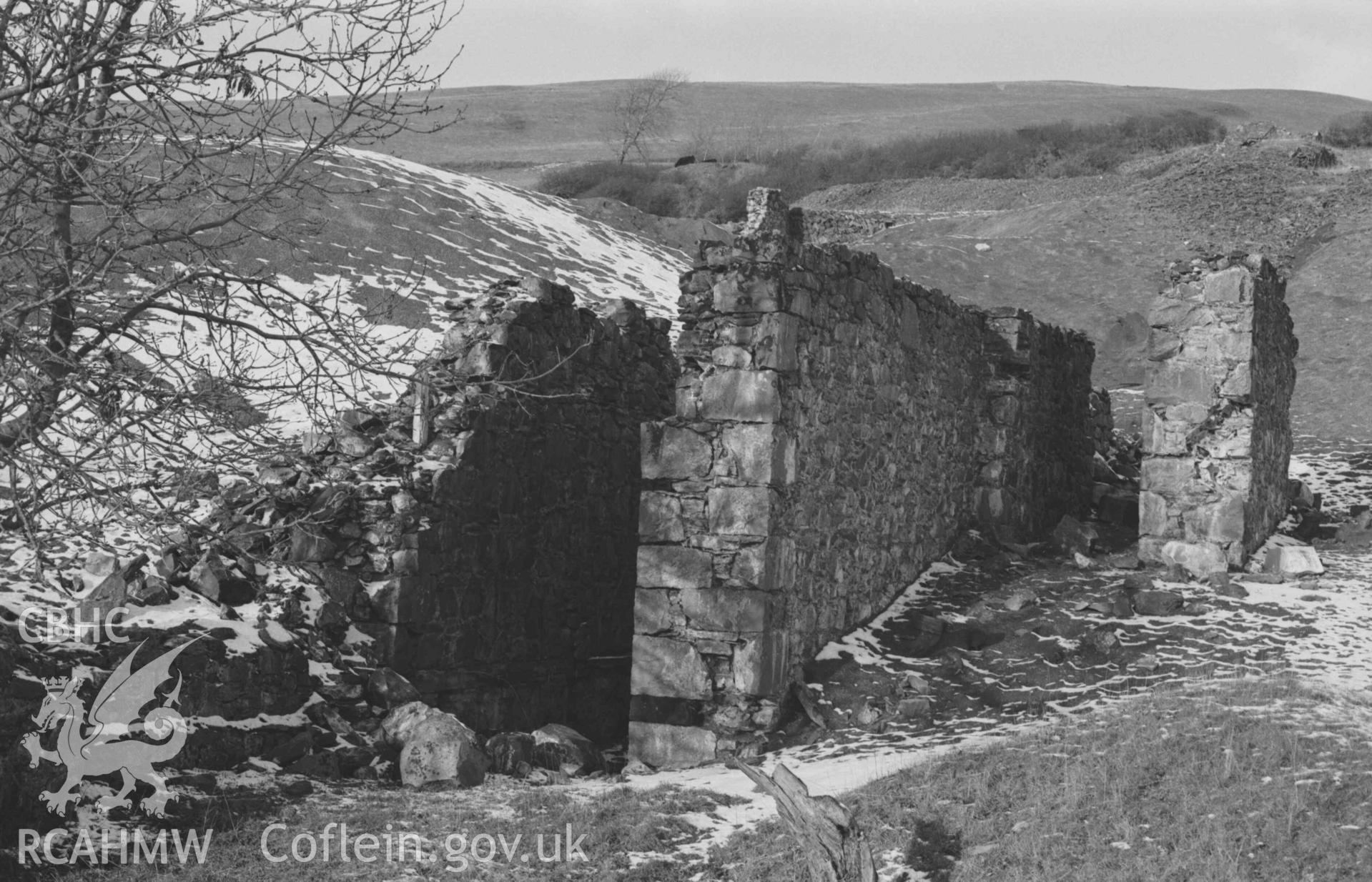 Digital copy of a black and white negative showing ruins of wheel pit and lower end of Mynydd-Gorddu mine. Photographed by Arthur Chater on 29 December 1968. Looking north north west from Grid Reference SN 6677 8590.