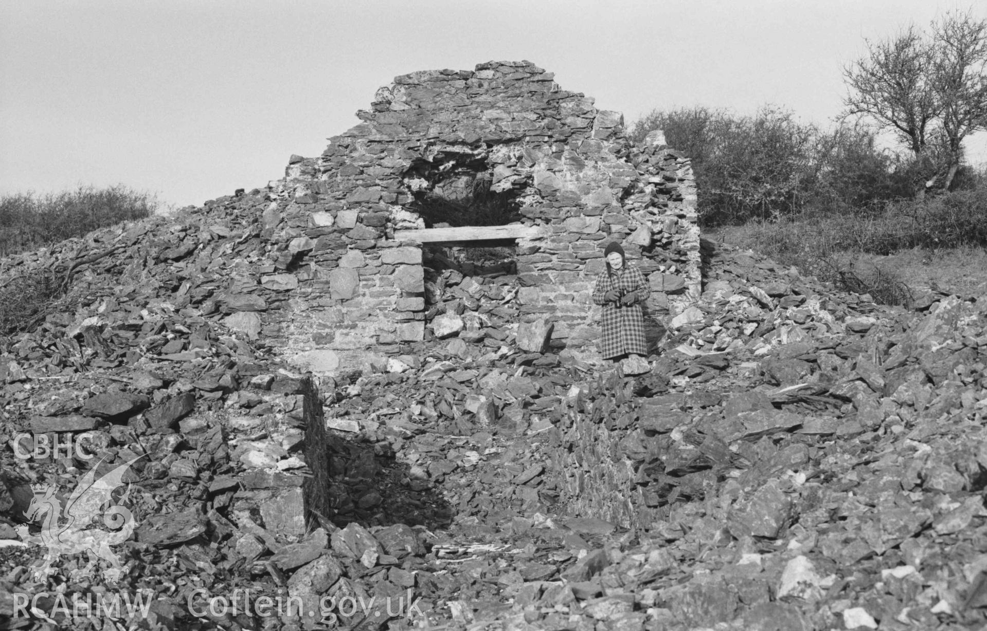 Digital copy of a black and white negative showing ruin 75m south south west of Mine Cottage, Mynydd-Gorddu mine, with large stone-lined funnel at the back. Photographed by Arthur Chater on 29 December 1968. Looking north north west from Grid Reference SN 6675 8602.