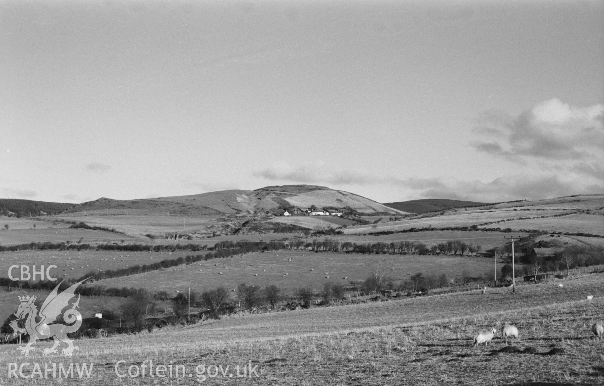 Digital copy of a black and white negative showing Darren camp, mine and village from the road south of Lluest-Fach, 1km south west. Photographed by Arthur Chater on 5 January 1969. Looking north east from Grid Reference SN 668 821.