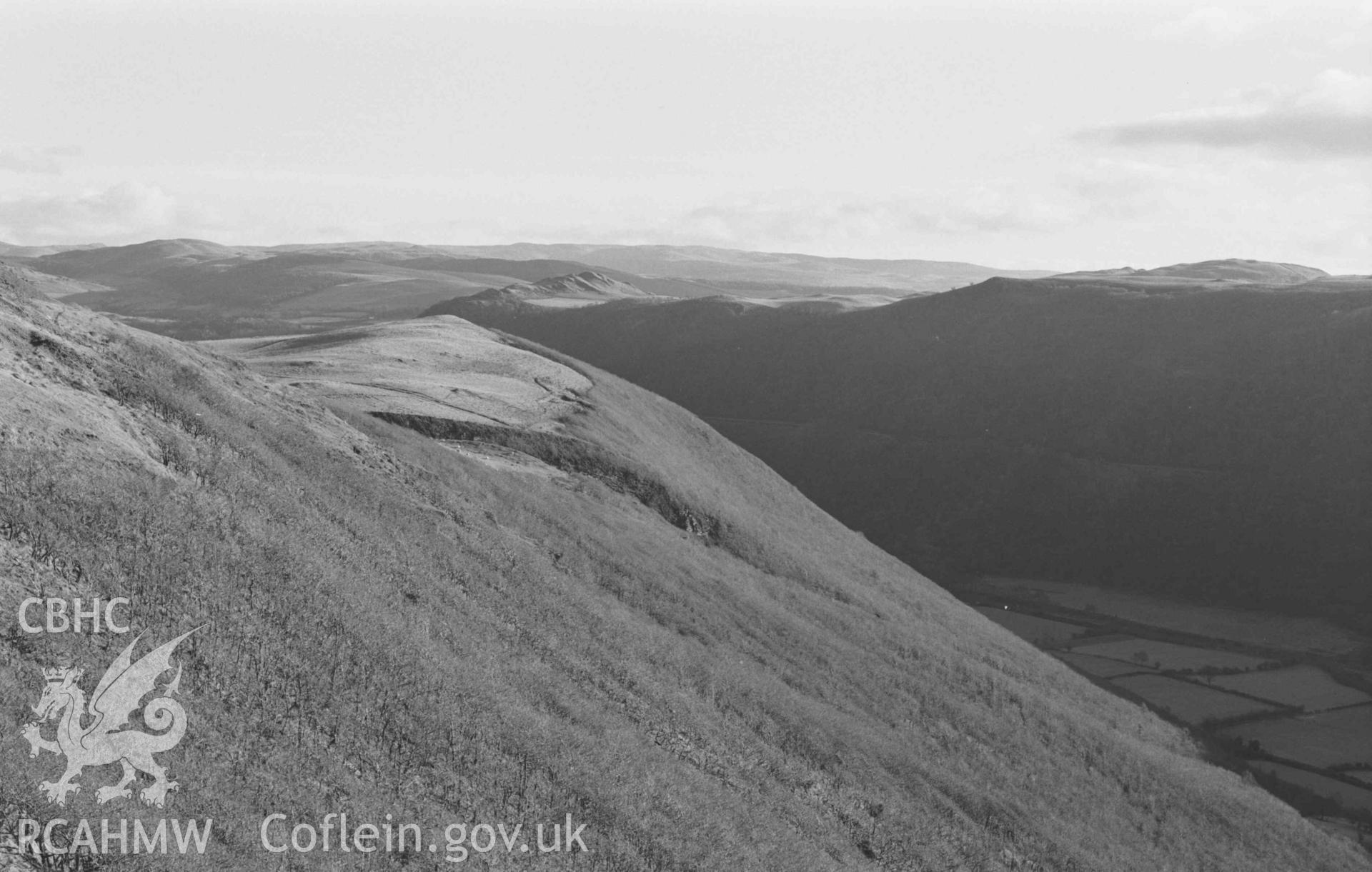 Digital copy of a black and white negative showing Castell Bwa Drain and the oakwood on the north side of the Rheidol valley (Panorama, photo 2 of 2). Photographed by Arthur Chater on 5 January 1969. Looking south east from Grid Reference SN 7105 7963.
