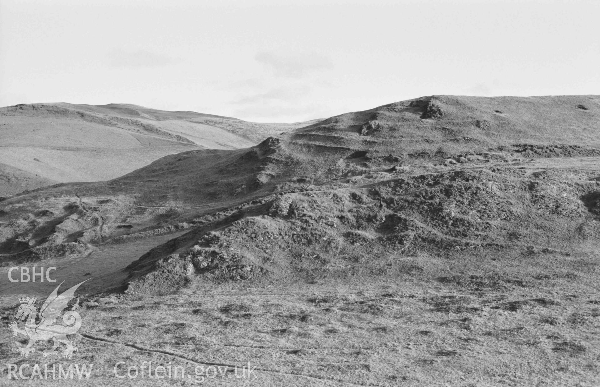 Digital copy of a black and white negative showing panorama of Castell Bwa Drain, with Bwa Drain farm on left and Rheidol Valley on right (photo 2 of 4). Photographed by Arthur Chater on 5 January 1969. Looking north east to south east from Grid Reference SN 712 795.