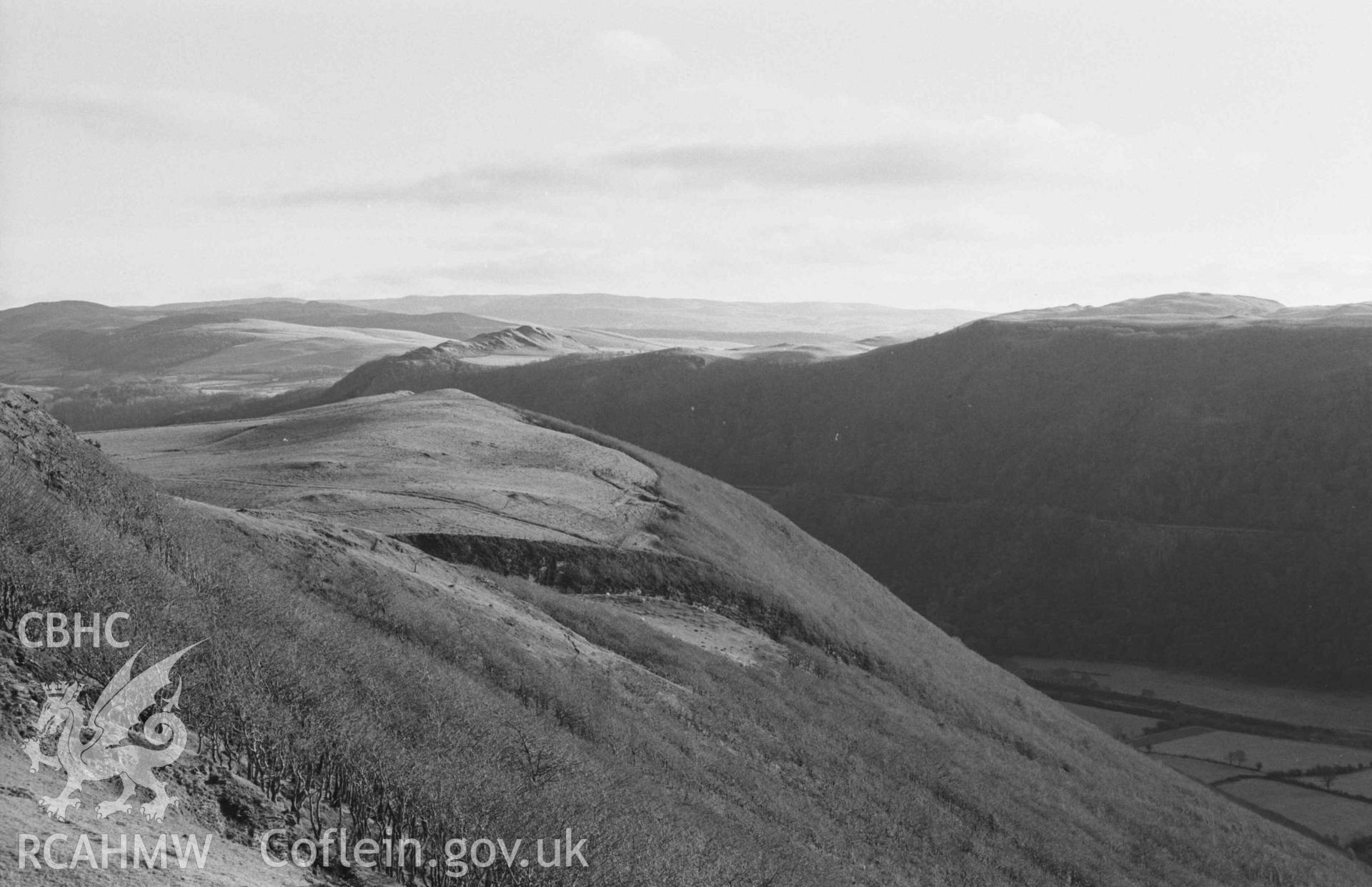 Digital copy of a black and white negative showing panorama of Castell Bwa Drain, with Bwa Drain farm on left and Rheidol Valley on right (photo 4 of 4). Photographed by Arthur Chater on 5 January 1969. Looking north east to south east from Grid Reference SN 712 795.