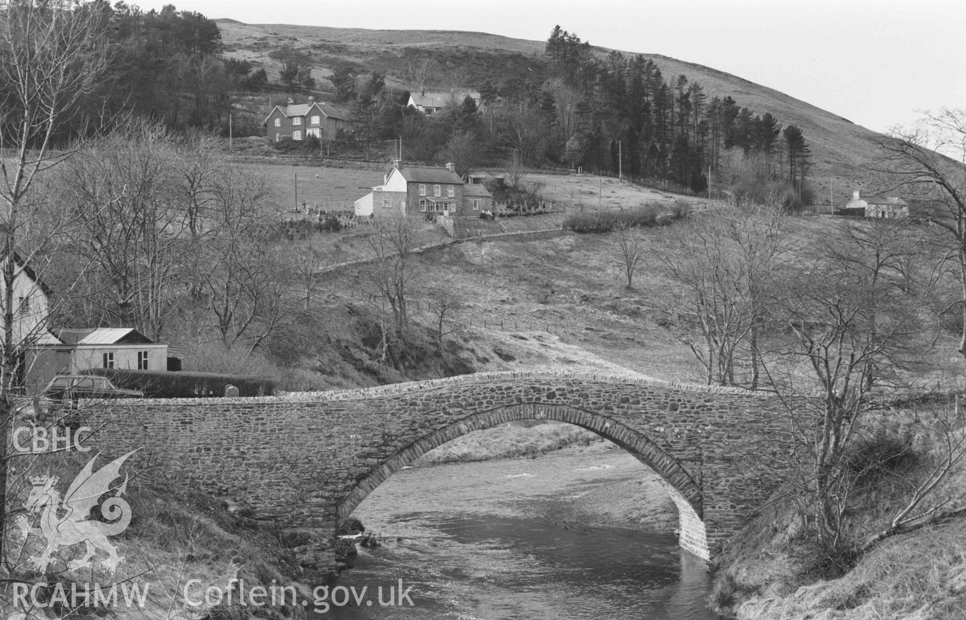 Digital copy of a black and white negative showing the old bridge from the new in Ponterwyd. Photographed by Arthur Chater on 2 April 1969. Looking north west from Grid Reference SN 7489 8082.