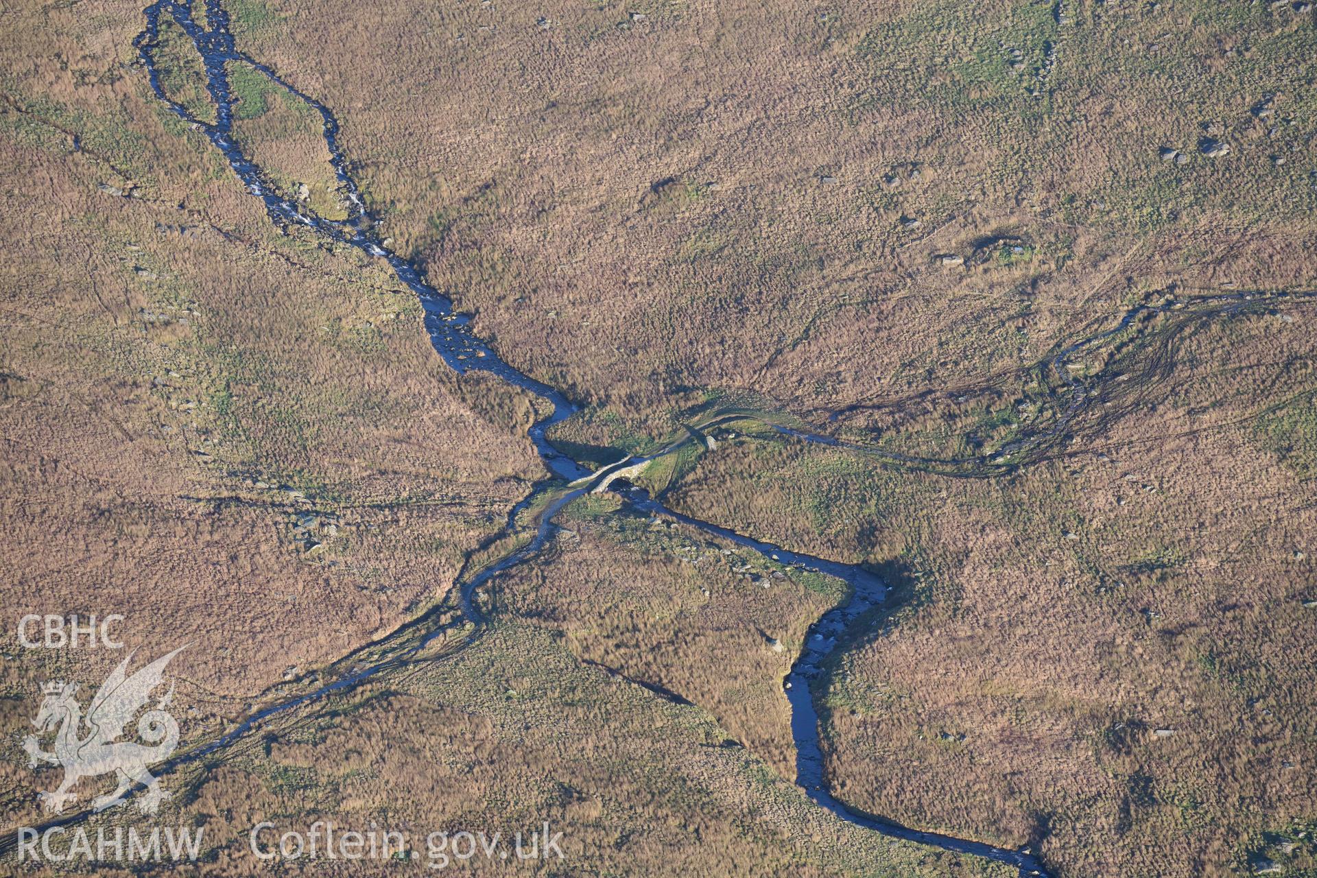 Oblique aerial photograph of Pont Scethin packhorse bridge taken during the Royal Commission’s programme of archaeological aerial reconnaissance by Toby Driver on 12th January 2022