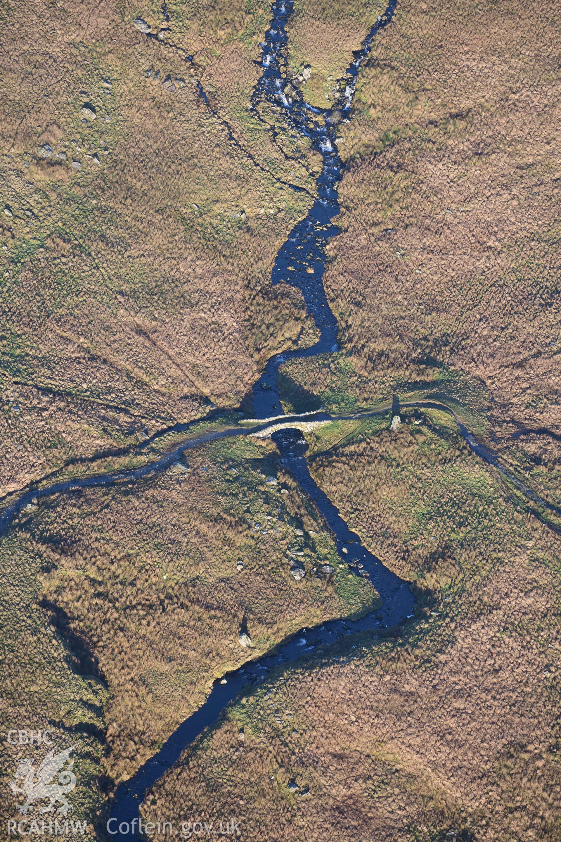 Oblique aerial photograph of Pont Scethin packhorse bridge taken during the Royal Commission’s programme of archaeological aerial reconnaissance by Toby Driver on 12th January 2022