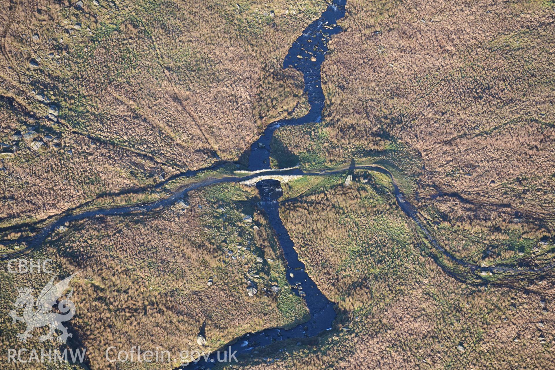 Oblique aerial photograph of Pont Scethin packhorse bridge taken during the Royal Commission’s programme of archaeological aerial reconnaissance by Toby Driver on 12th January 2022