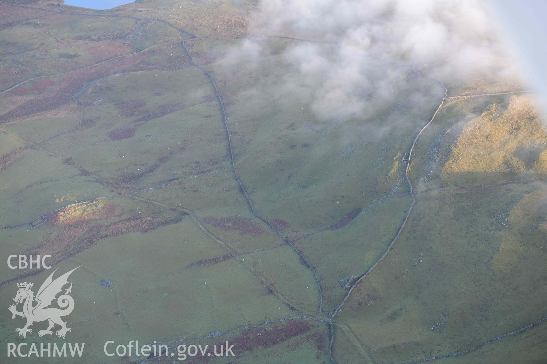 Oblique aerial photograph of Ffridd Fedw huts and enclosures at left of frame, view from W, taken during the Royal Commission