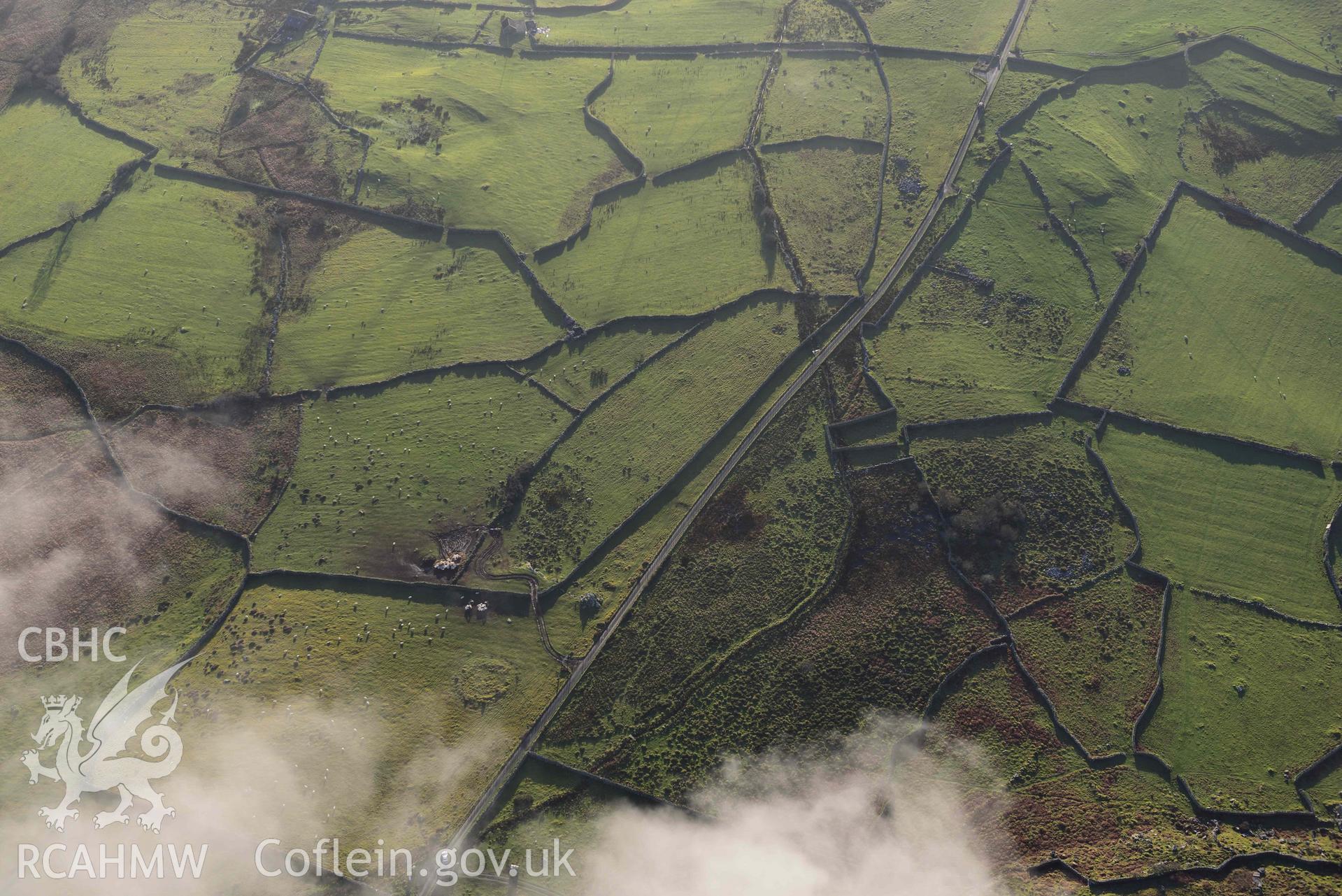 Oblique aerial photograph of Carreg round cairn and standing stone taken during the Royal Commission