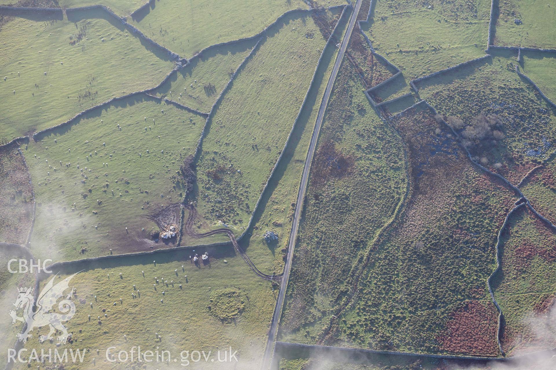 Oblique aerial photograph of Carreg round cairn and standing stone taken during the Royal Commission