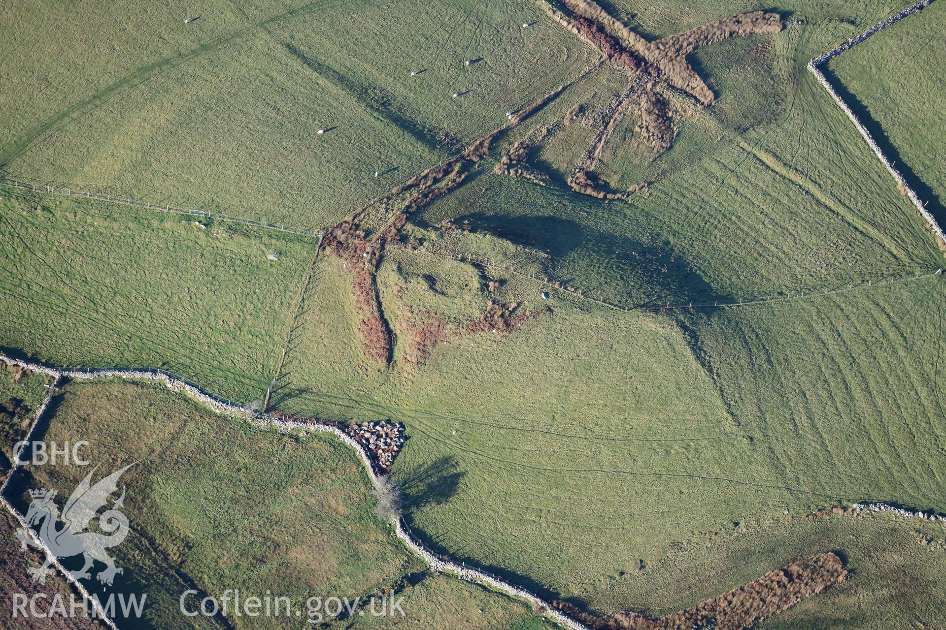 Oblique aerial photograph of Tan y Rhiw enclosed hut circle taken during the Royal Commission