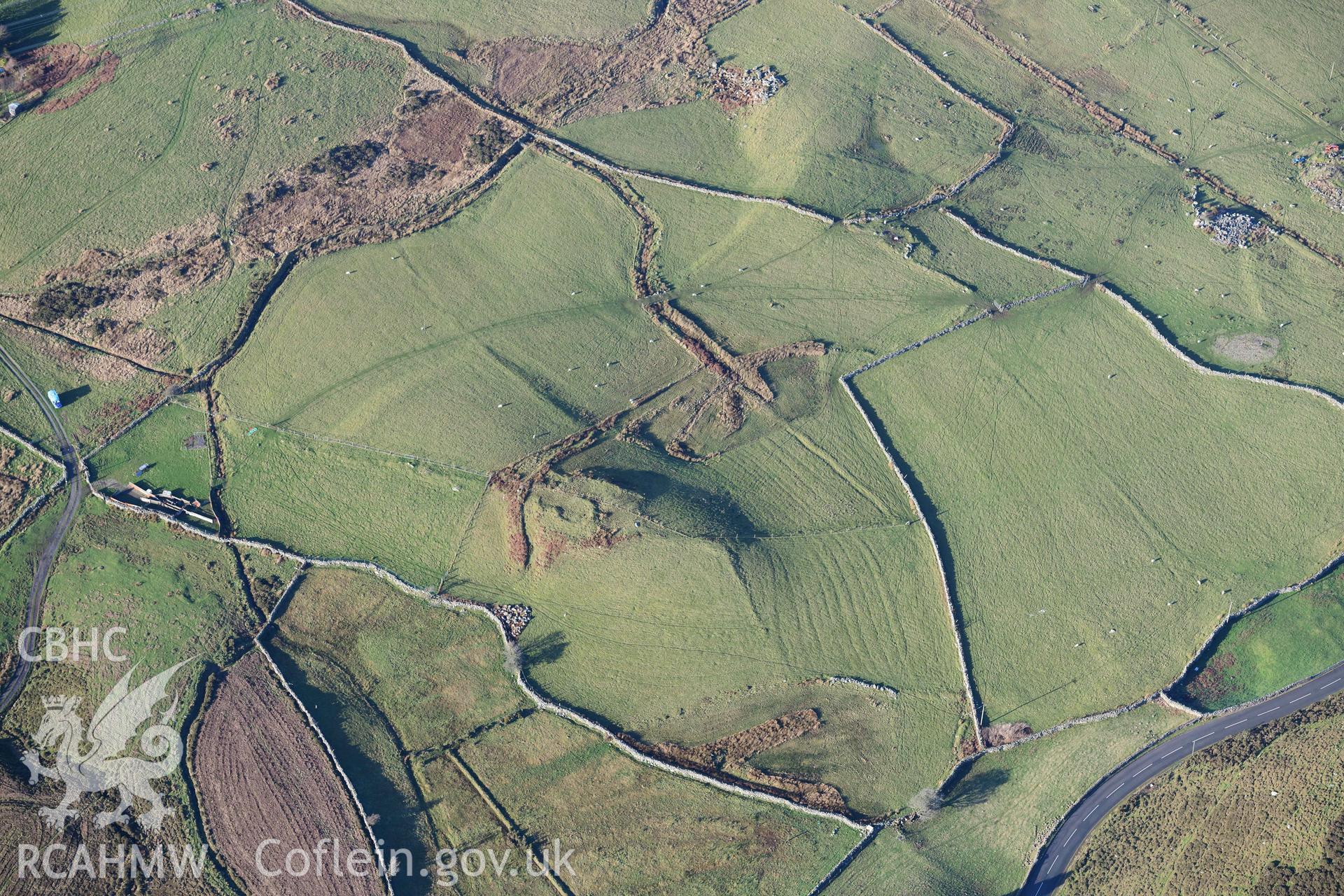 Oblique aerial photograph of Tan y Rhiw enclosed hut circle taken during the Royal Commission