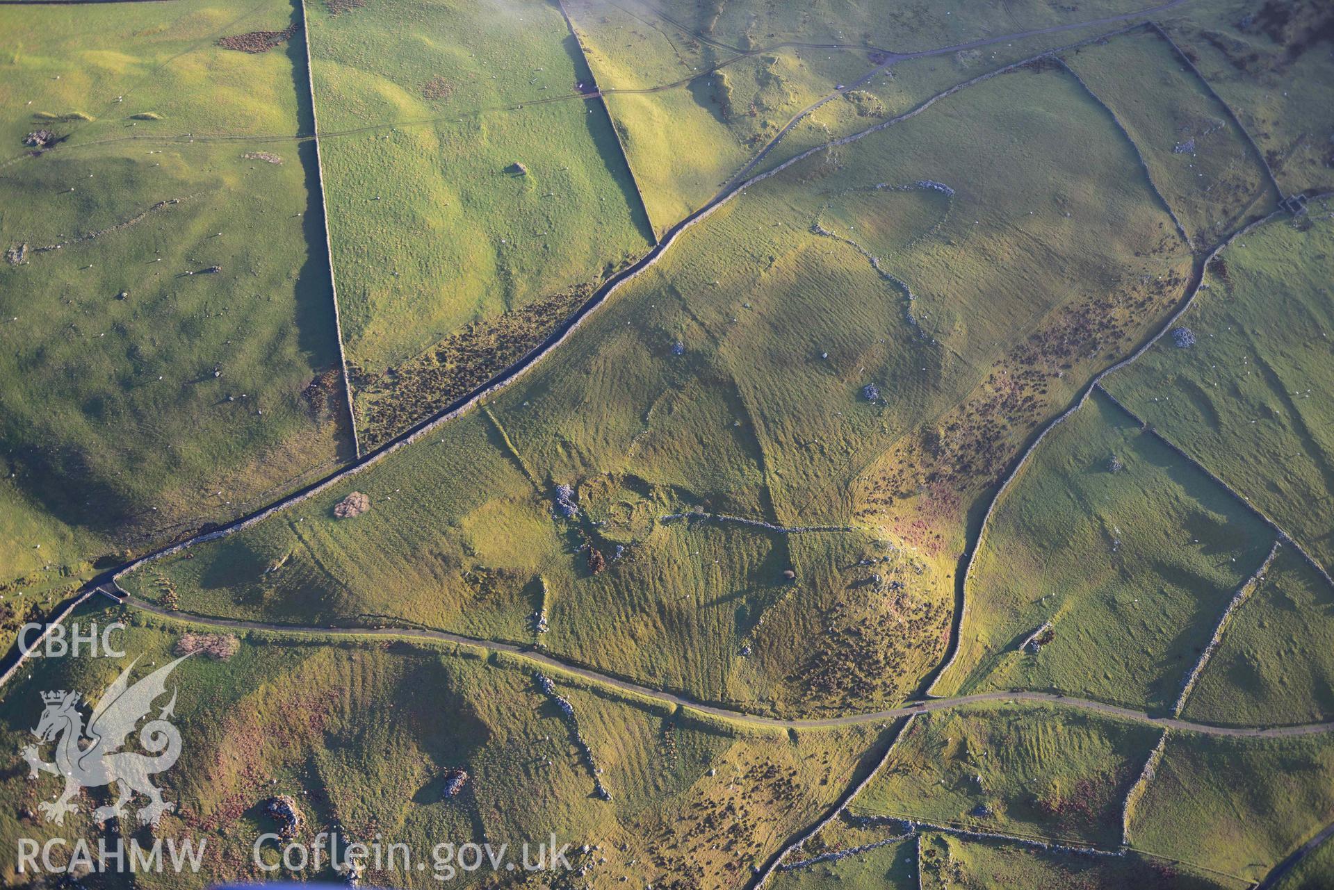 Oblique aerial photograph of Erw Wen prehistoric and medieval settlement, and fields. Taken during the Royal Commission