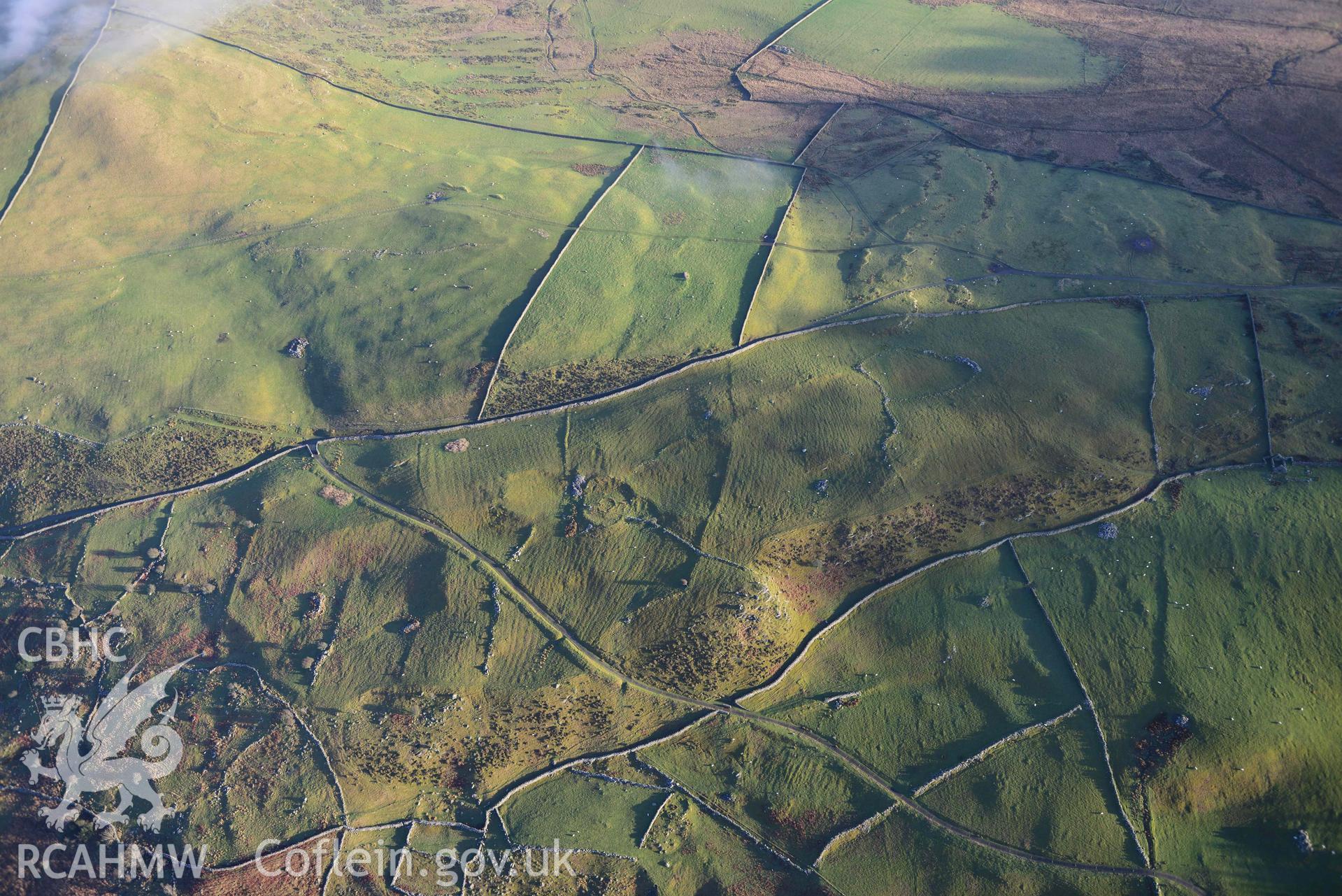 Oblique aerial photograph of Erw Wen prehistoric and medieval settlement, wide landscape view from NW. Taken during the Royal Commission