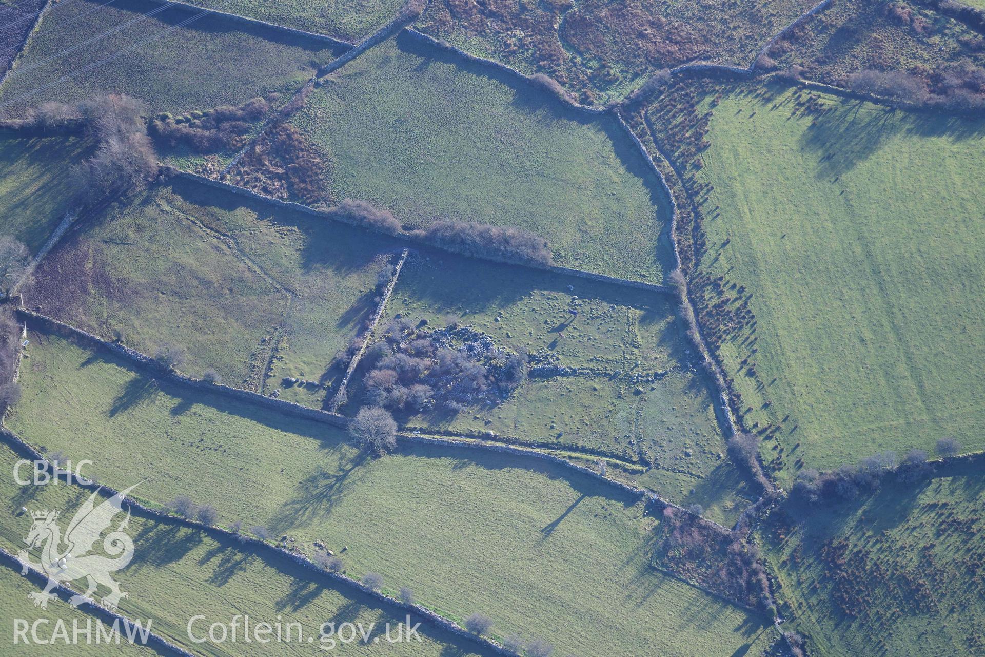 Oblique aerial photograph of Pen Llwyn hut group taken during the Royal Commission