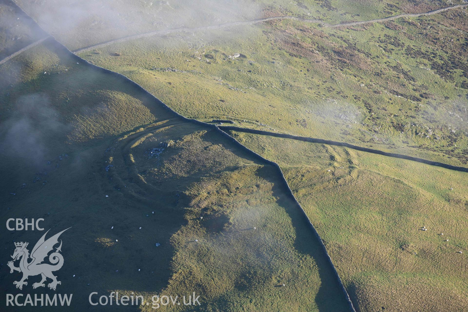 Oblique aerial photograph of Moel Goedog hillfort taken during the Royal Commission