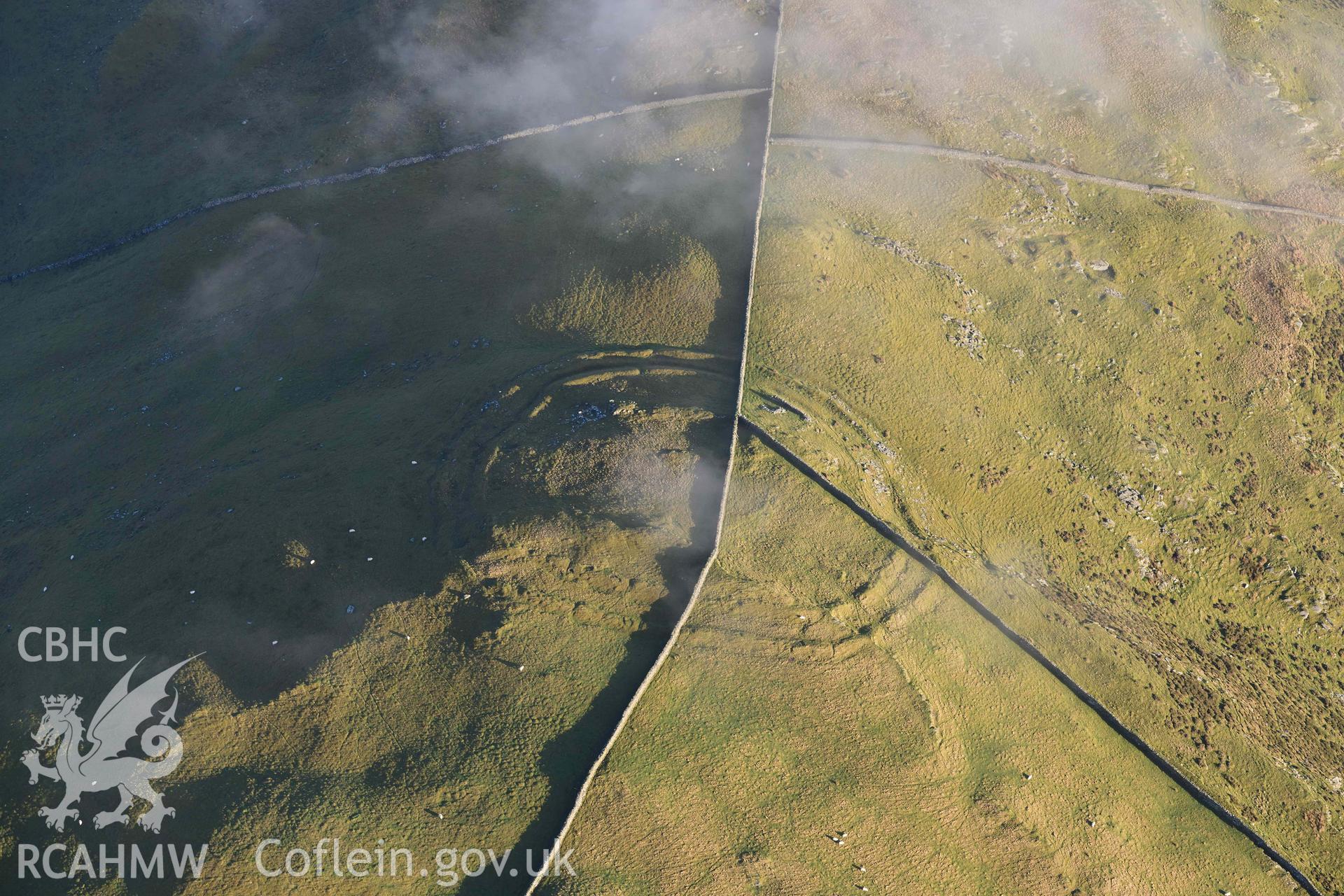 Oblique aerial photograph of Moel Goedog hillfort taken during the Royal Commission