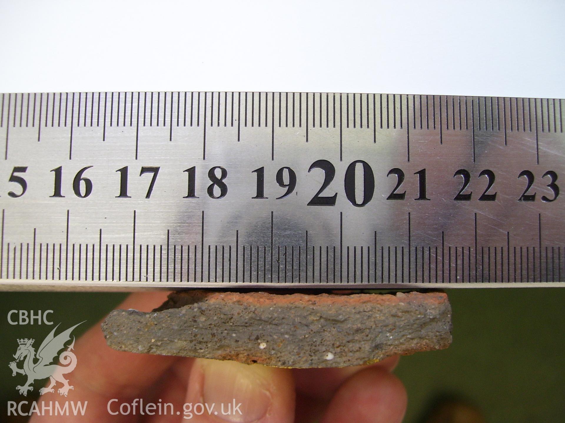 Digital photograph showing find, with scale, discovered at 1A White Hart Lane and 30 High Street (Bank House), Caerleon. Produced by M. Lewis, National Roman Legion Museum. August 2012.