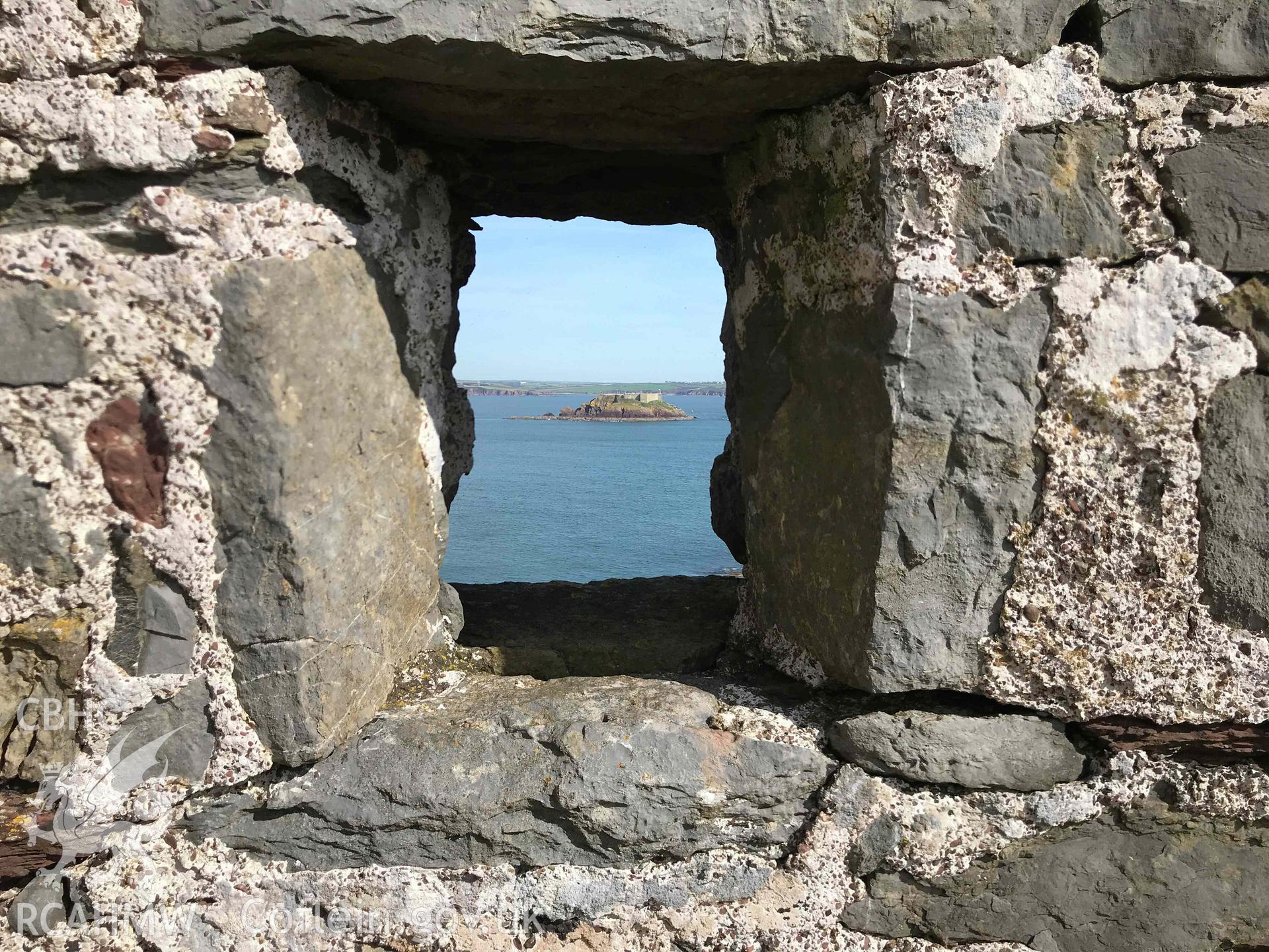 Digitised photograph showing view through window space towards 'rat island' at East Blockhouse, Angle. Produced by Paul Davis in 2020