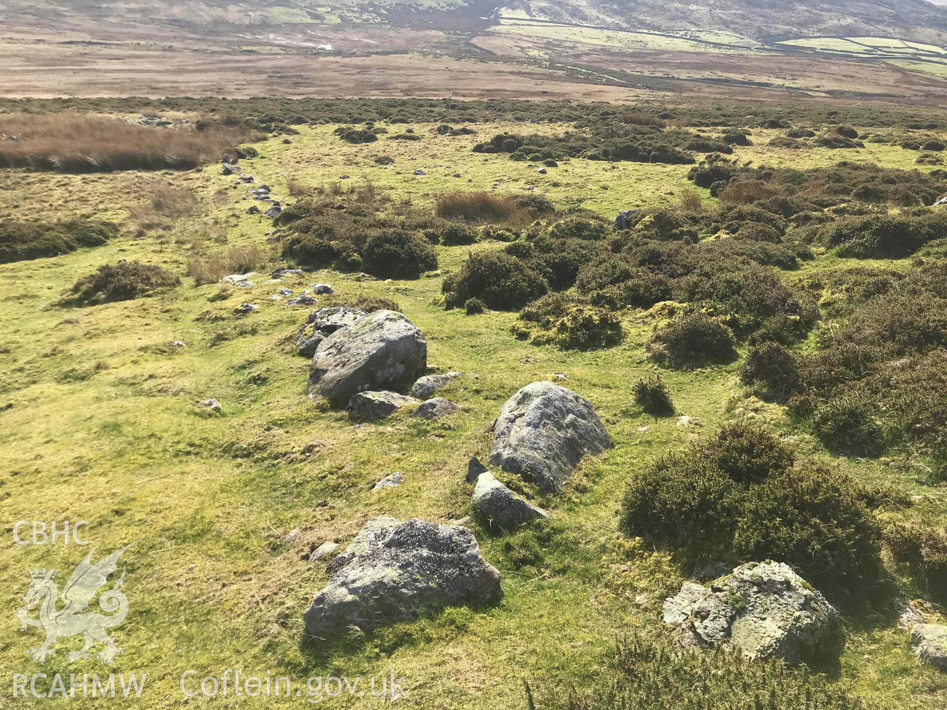 Digital photograph showing boulders in stony bank at Moel Faban settlement, produced by Paul Davis in 2020