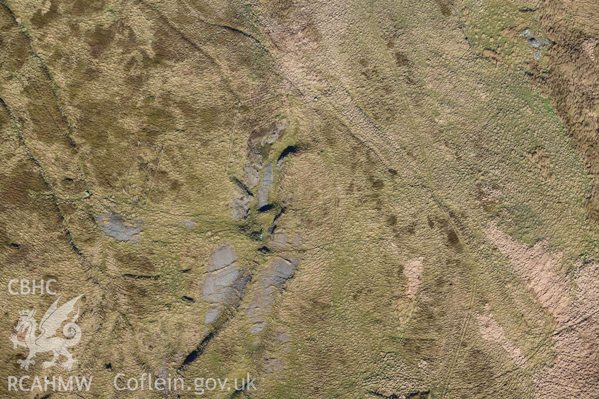 Oblique aerial photograph showing detail of Bronze Age opencast at Copa Hill. Taken during the Royal Commission’s programme of archaeological aerial reconnaissance by Toby Driver on 17th January 2022