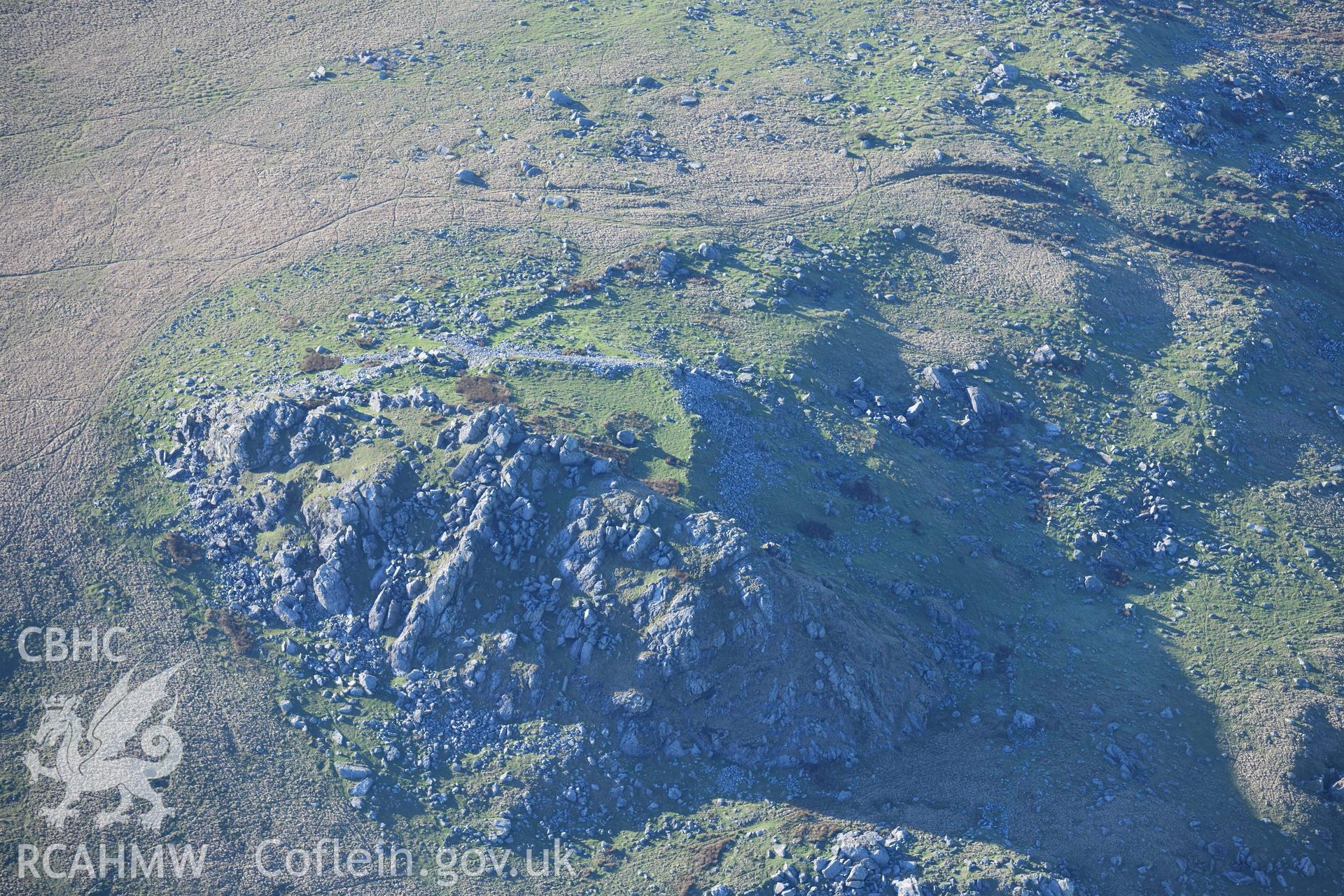 Oblique aerial photograph showing view from the north east of Carn Alw hillfort taken during the Royal Commission’s programme of archaeological aerial reconnaissance by Toby Driver on 17th January 2022