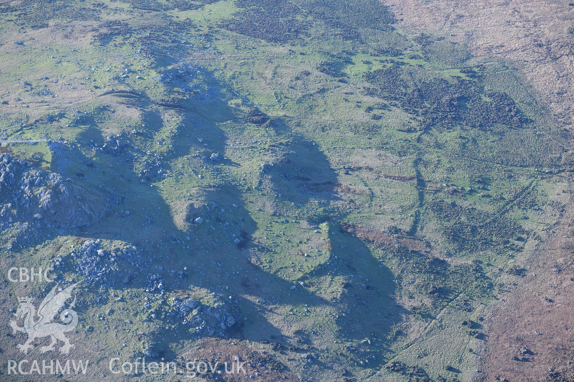 Oblique aerial photograph showing view from the north east of Carn Alw hillfort taken during the Royal Commission’s programme of archaeological aerial reconnaissance by Toby Driver on 17th January 2022