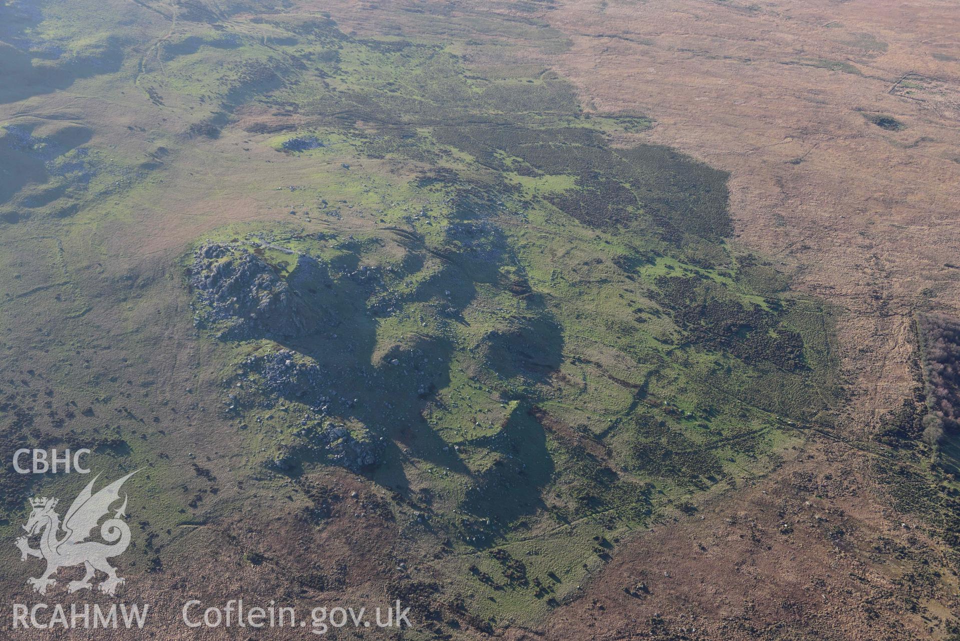 Oblique aerial photograph showing view from the north east of Carn Alw hillfort taken during the Royal Commission’s programme of archaeological aerial reconnaissance by Toby Driver on 17th January 2022