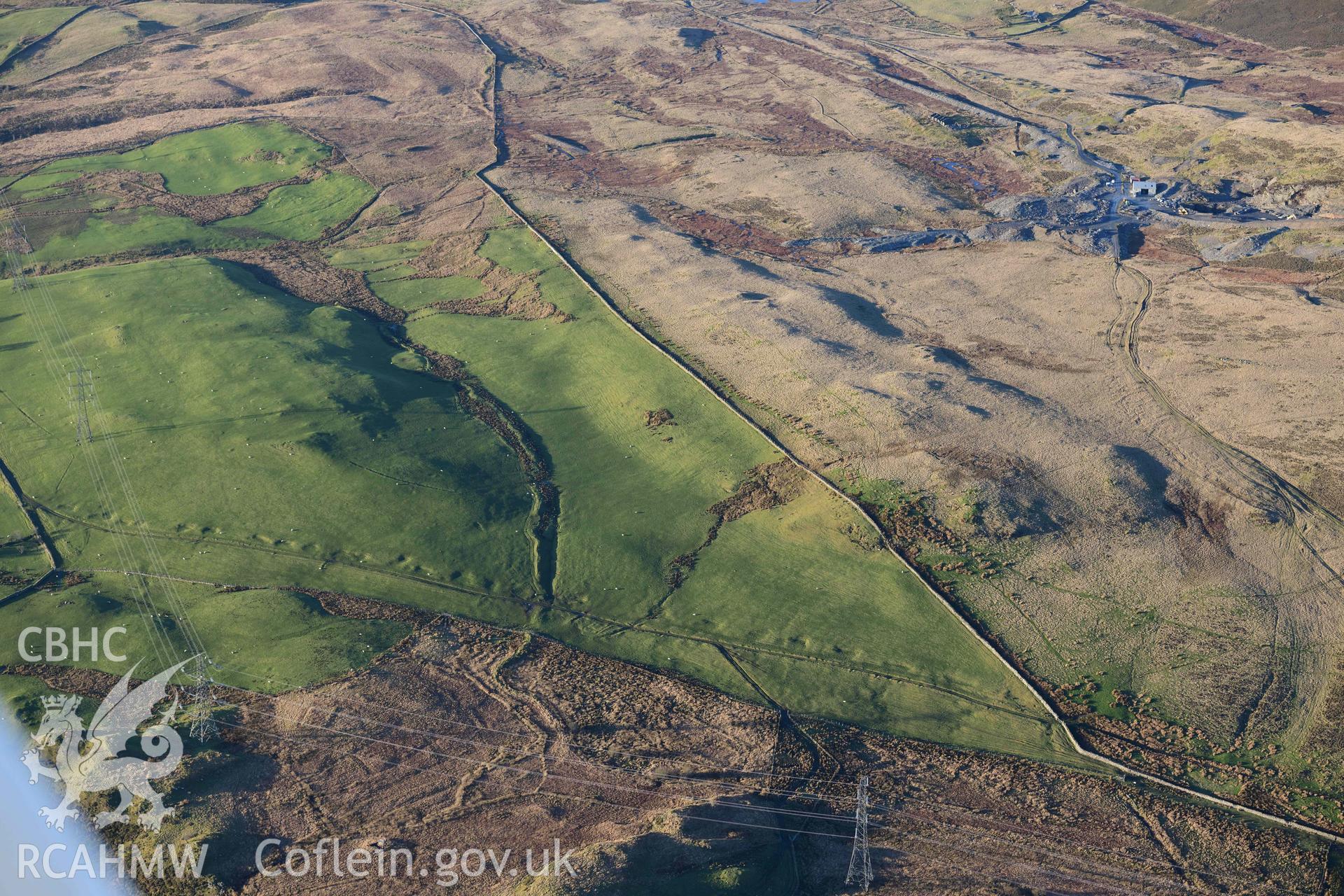 Oblique aerial photograph of Dolbelydr Roman road with quarry pits. Taken during the Royal Commission’s programme of archaeological aerial reconnaissance by Toby Driver on 17th January 2022