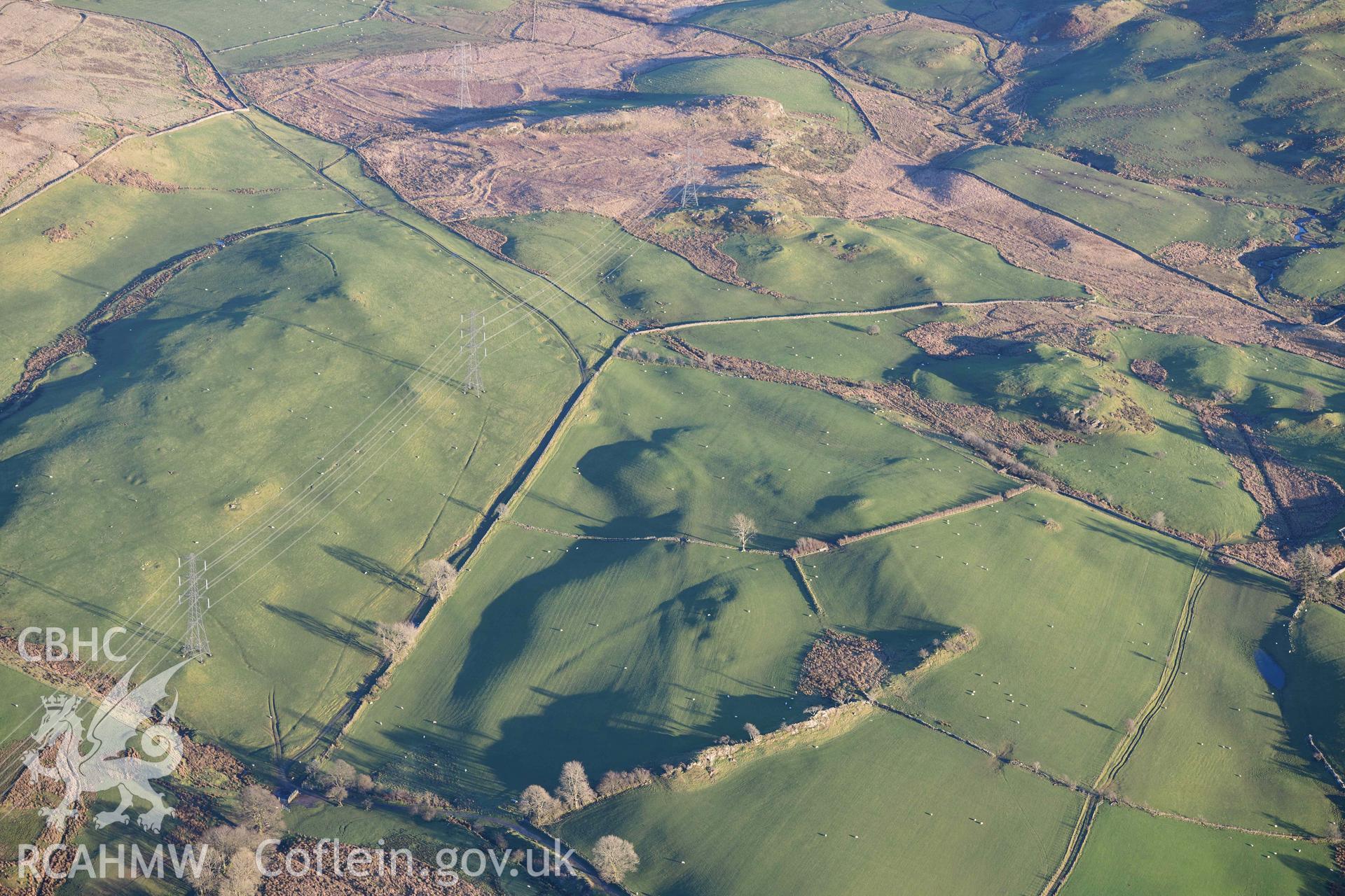 Oblique aerial photograph of Dolbelydr Roman road with quarry pits, view looking east. Taken during the Royal Commission’s programme of archaeological aerial reconnaissance by Toby Driver on 17th January 2022