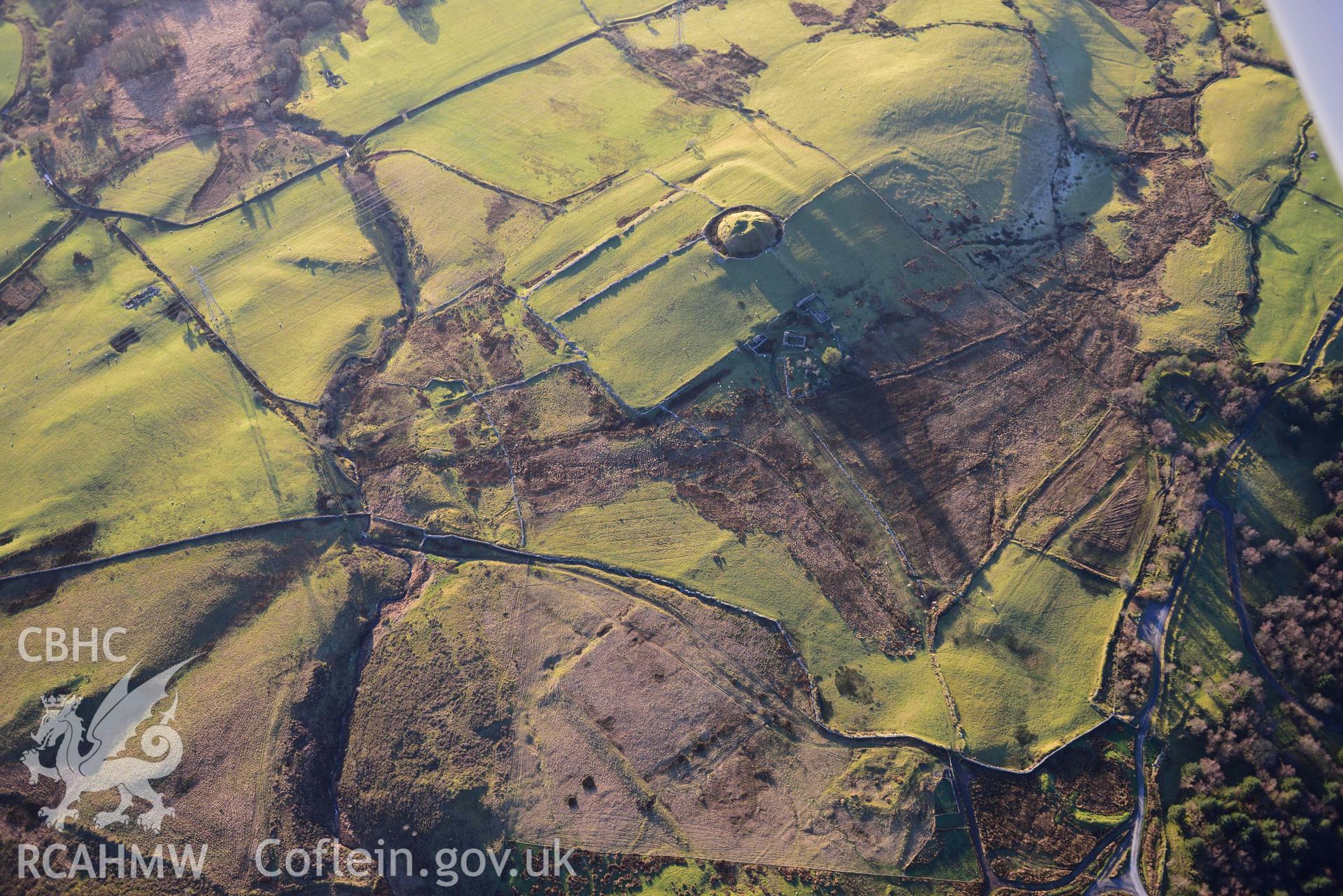 Oblique aerial photograph of Tomen y Mur Roman fort and earthwork complex, viewed from the north east. Taken during the Royal Commission’s programme of archaeological aerial reconnaissance by Toby Driver on 17th January 2022