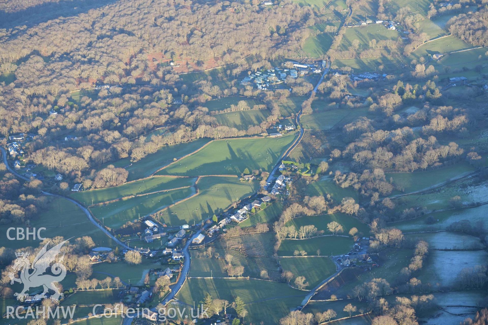 Oblique aerial photograph showing wide landscape view of Brithdir Roman fort from the west. Taken during the Royal Commission’s programme of archaeological aerial reconnaissance by Toby Driver on 17th January 2022