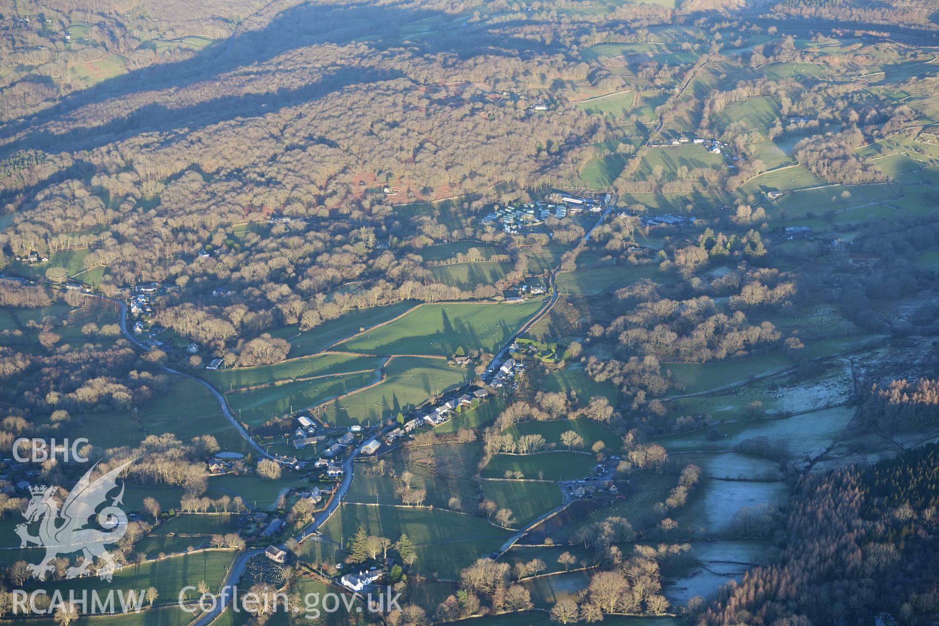 Oblique aerial photograph showing wide landscape view of Brithdir Roman fort from the west. Taken during the Royal Commission’s programme of archaeological aerial reconnaissance by Toby Driver on 17th January 2022