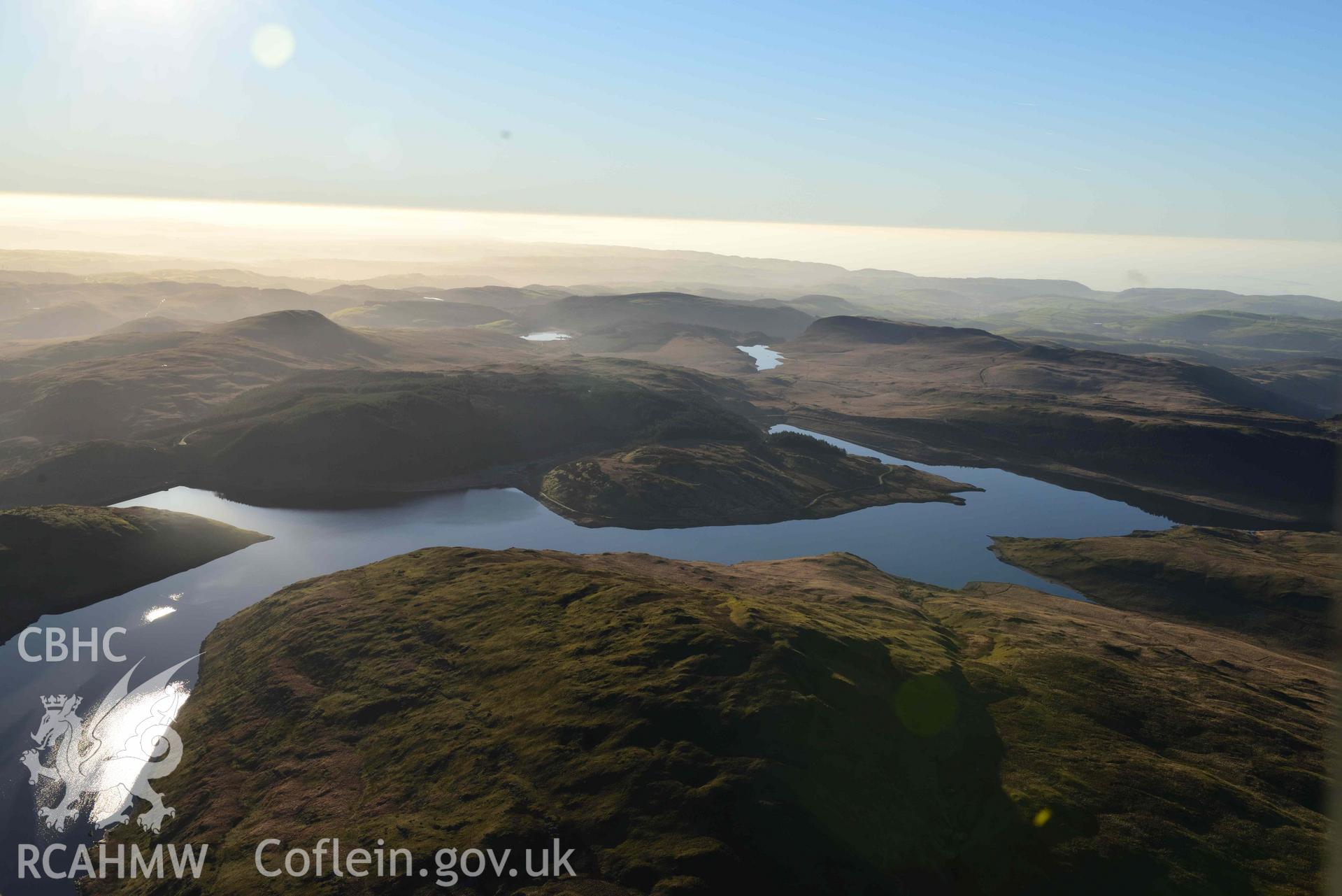 Oblique aerial photograph showing high view from the east of Nant y Moch reservoir and dam. Taken during the Royal Commission’s programme of archaeological aerial reconnaissance by Toby Driver on 17th January 2022